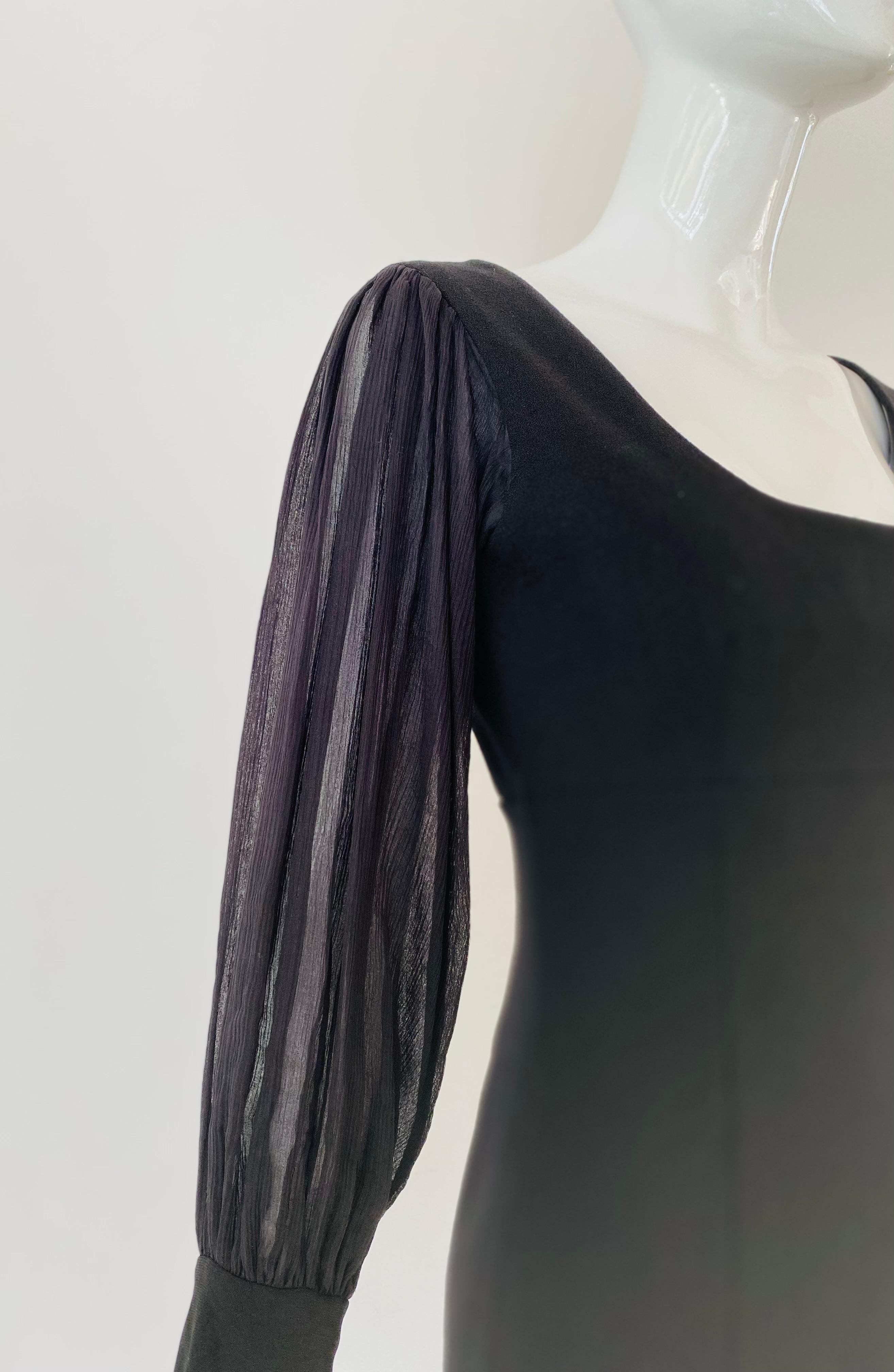 2000s Little black dress by Gianfranco Ferre. The hem falls right above the knee and has beautiful sheer ballon long sleeves. It has a scoop neck and a little sheer fabric on the back between the scoop neck and the rest of the dress, connecting the