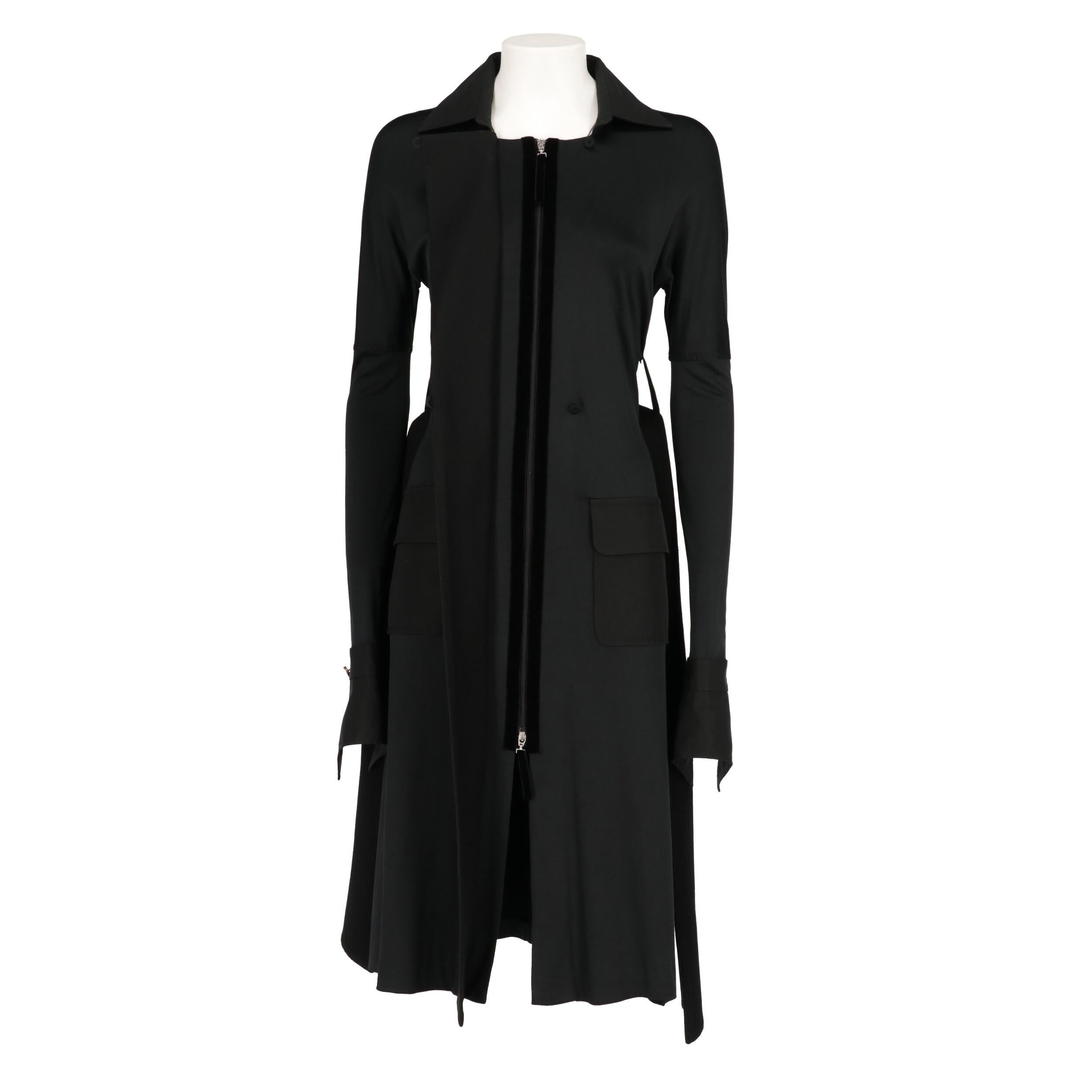 Gianfranco Ferré black viscose blend overcoat. Classic collar, zip and buttons  closure and belt at the waist. Drop shoulders, long sleeves and flap pockets.

The product shows some unstitched threads as shown in the pictures.
Year: 2007

Made in
