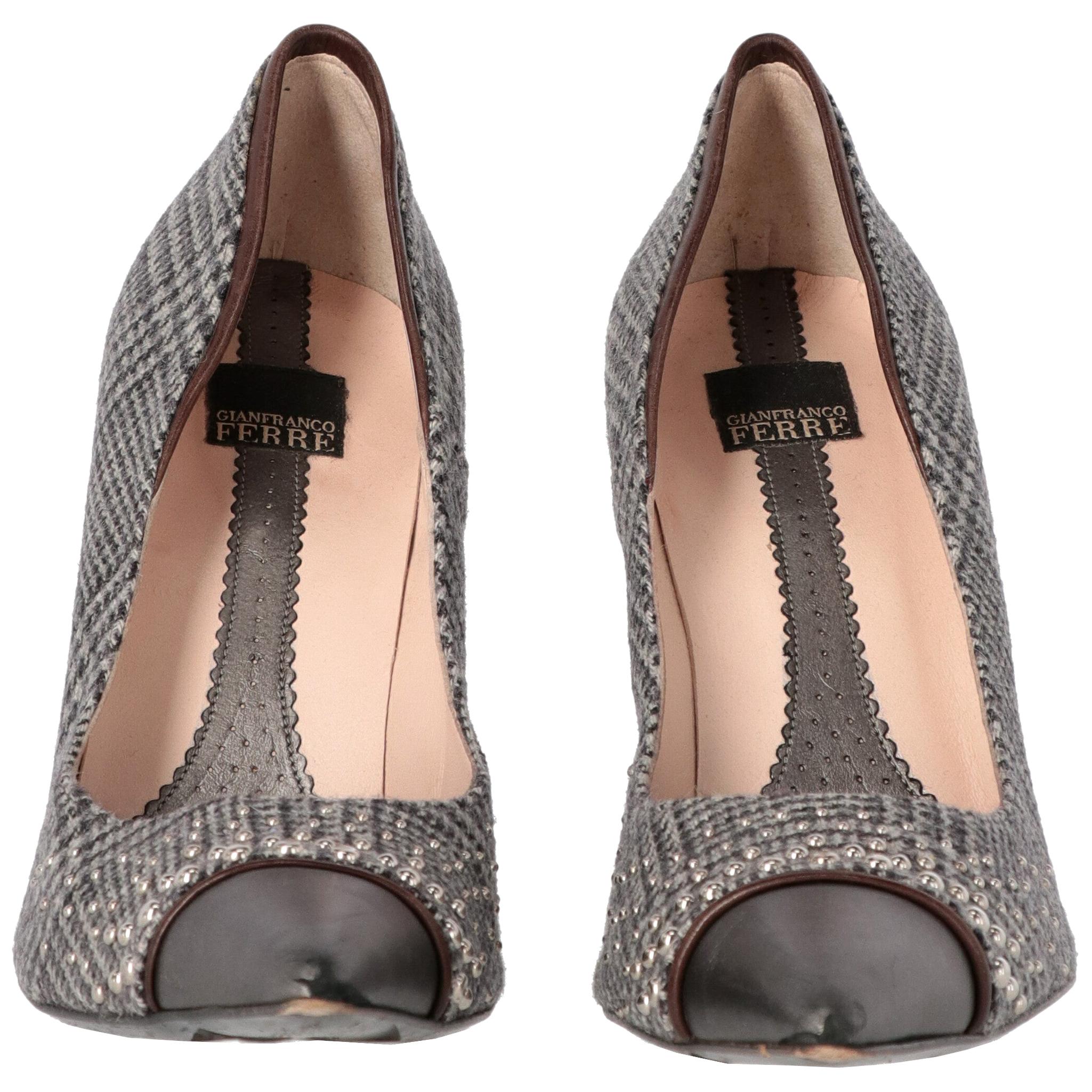Gianfranco Ferré Prince of Wales grey wool pumps. Contrasting metallic grey leather toe cap with brown hem. Decorated with shiny silver-tone metal semispherical studs of different sizes. Pointed toe and thin heel.

The shoes show some light signs of