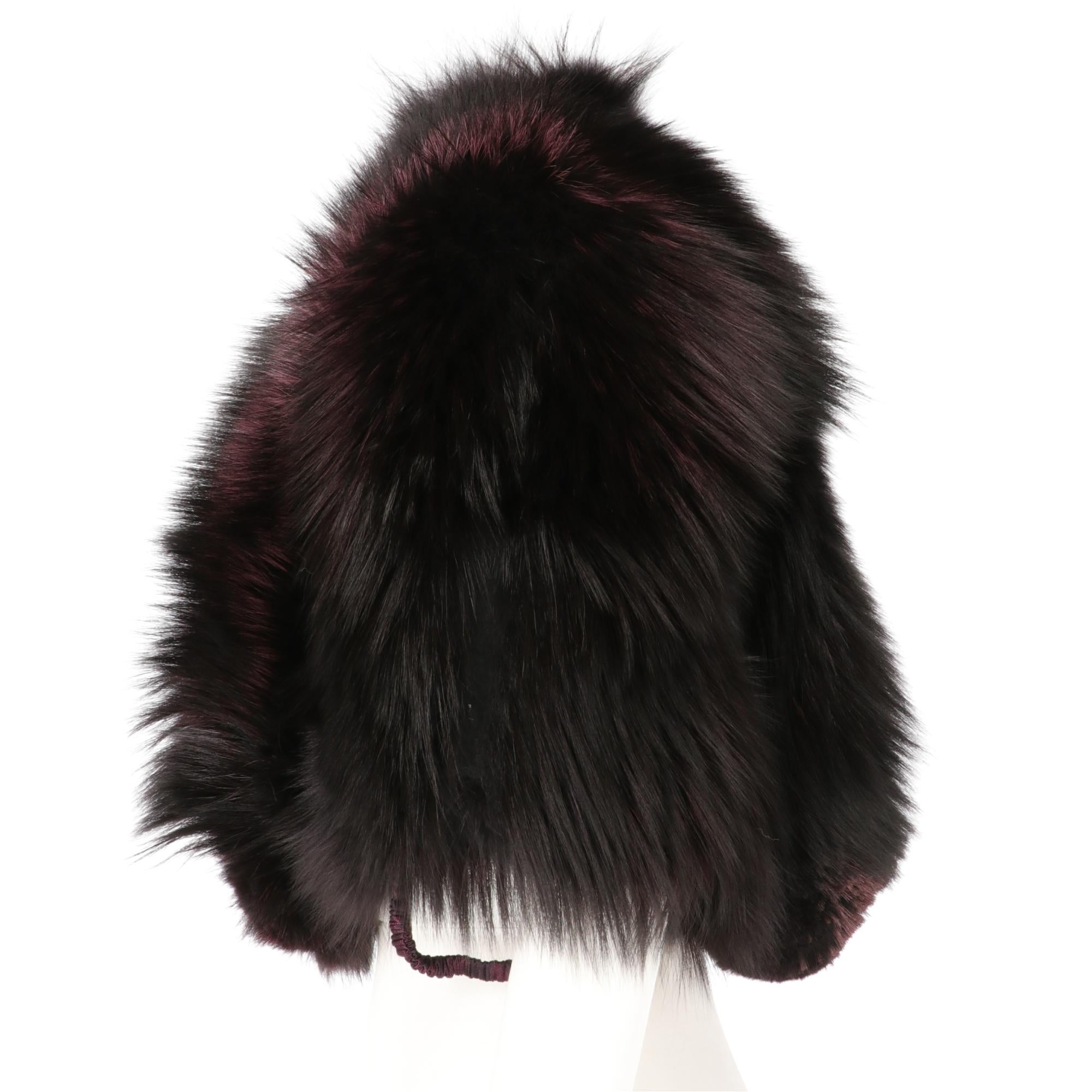 Gianfranco Ferrè real silver fox fur short to the waist cape, dyed in purple color with padded shoulders, leather inserts, elastics and hooks for the arms, lined in silk jacquard, front closure with hook and chain.

This item belongs to an original