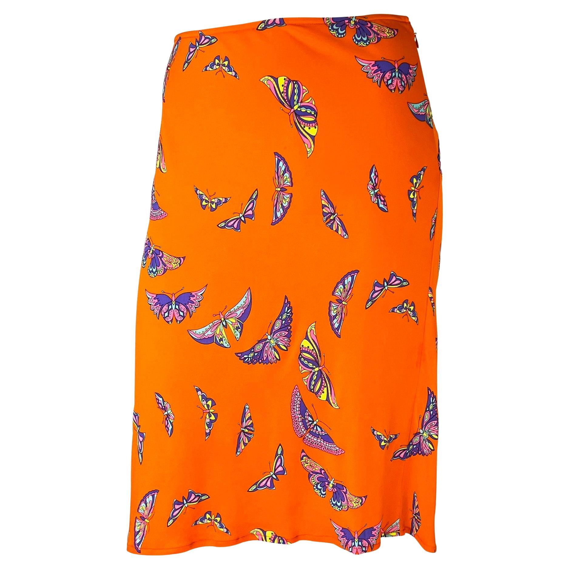 Presenting a bright orange Gianni Versace Couture skirt, designed by Donatella Versace. From the late 1990s, this orange handkerchief-style skirt is covered in multicolored butterflies. With a hippy-inspired feel, this is the perfect vibrant piece