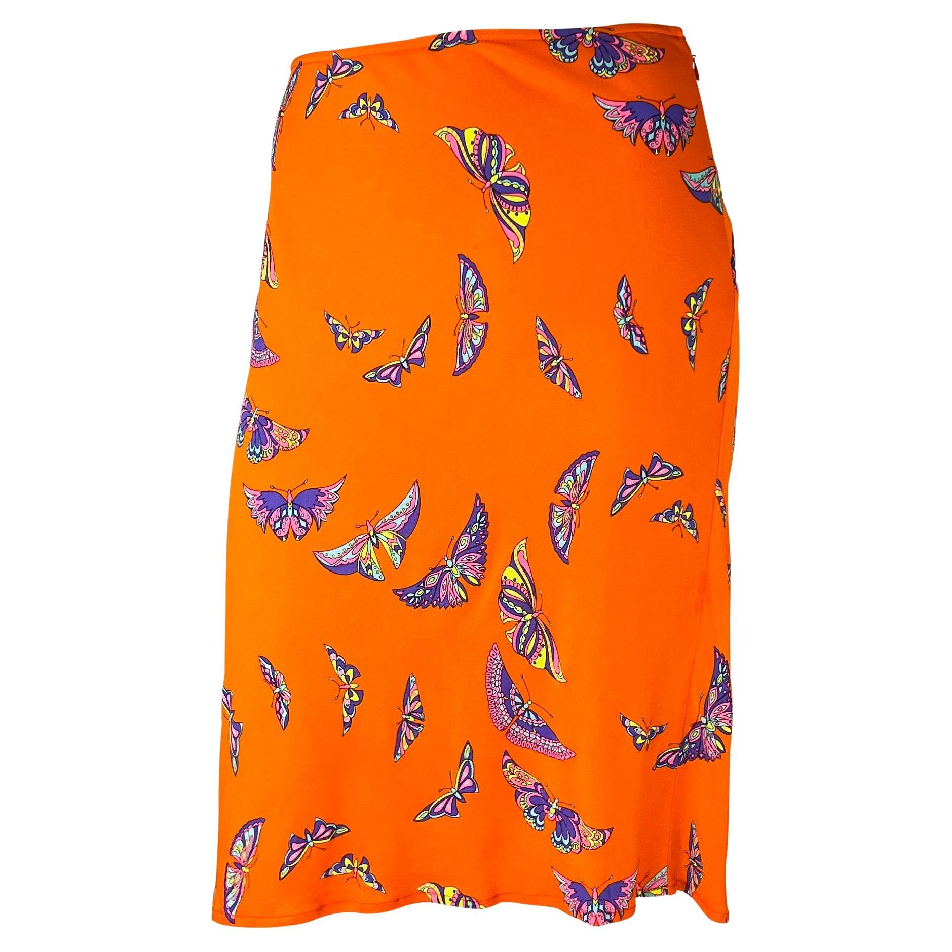 Presenting a bright orange Gianni Versace Couture skirt designed by Donatella Versace. From the late 1990s, this orange handkerchief-style skirt is covered in multicolored butterflies. With a hippy-inspired feel, this is the perfect vibrant piece to