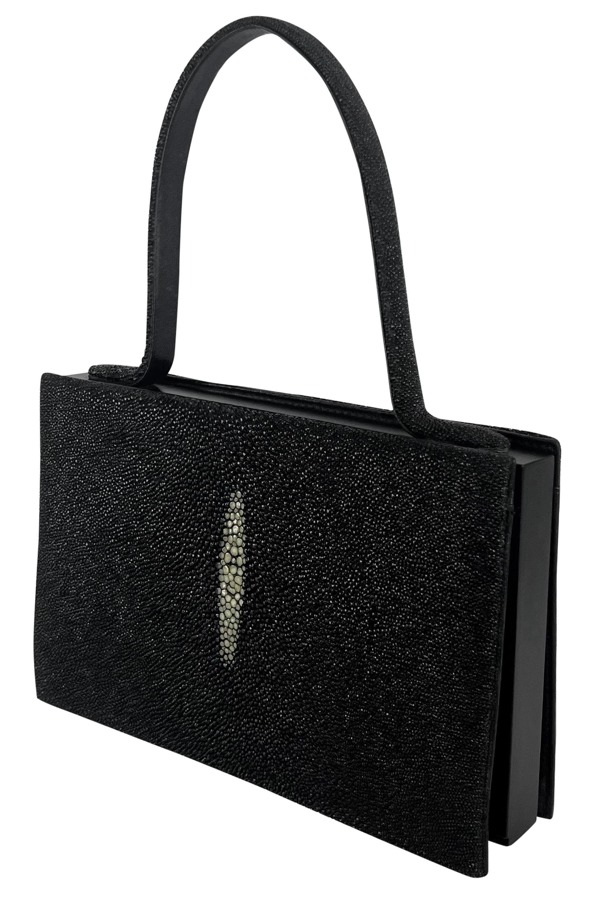 This stunning Giorgio Armani top-handle mini bag from the 1990s is crafted from faux black stingray skin, featuring distinctive off-white detailing at the center on both sides. The bag's scaly texture and rectangular shape make it the perfect petite