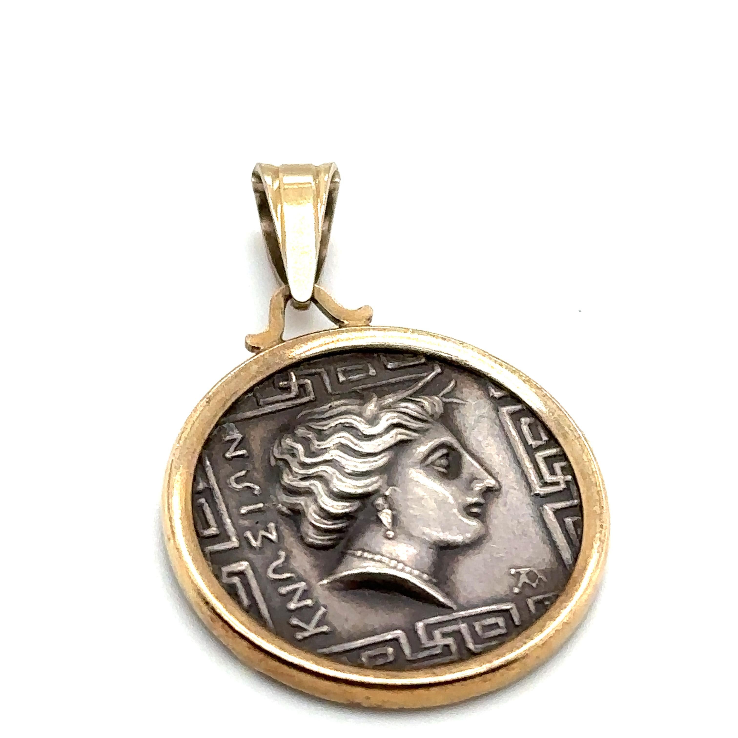 Item Details: This coin pendant has a design of the Greek god Athena with the word 