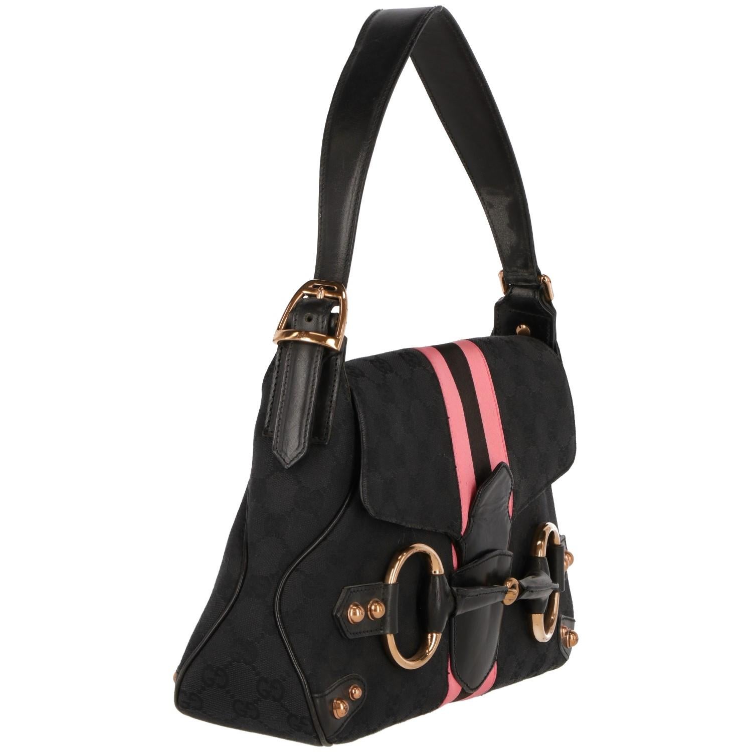 The lovely Gucci shoulder bag is made in Italy, with authentic code and in good conditions.  In black synthetic monogram fabric and pink stripes, it features black leather details and one short adjustable black leather shoulder strap, it features