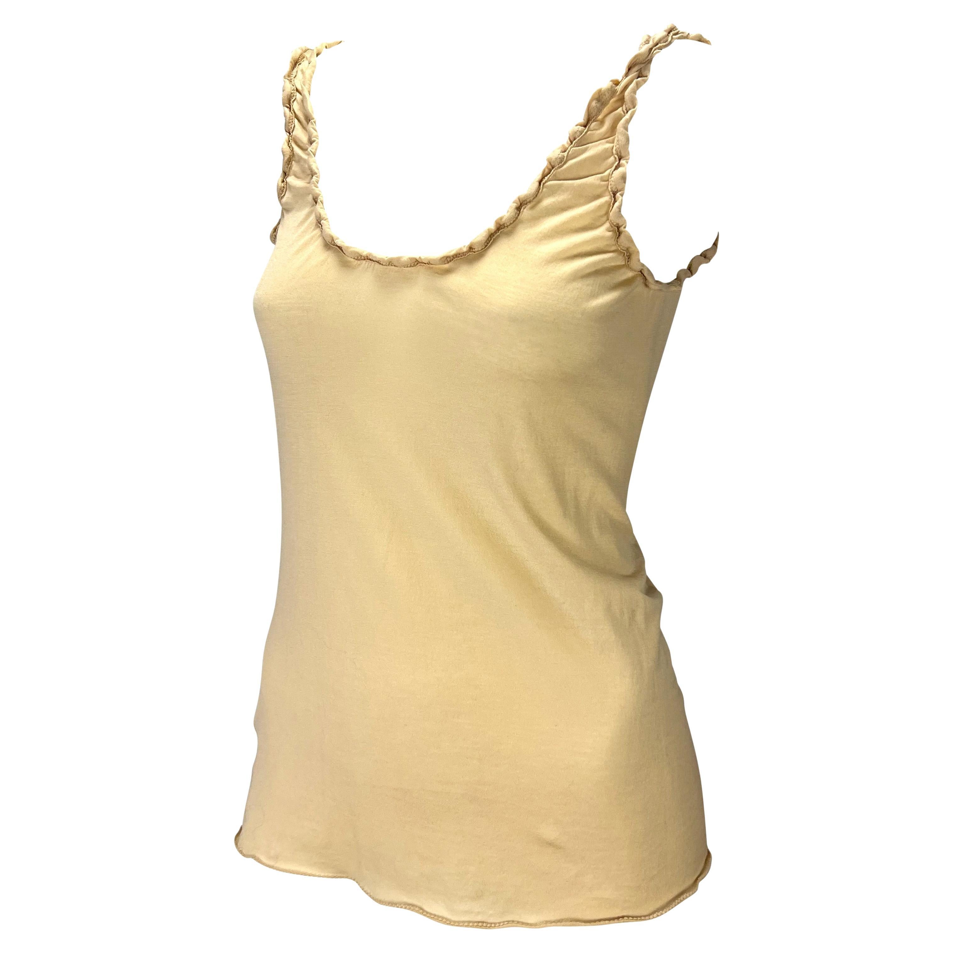 Presenting a ruched beige Gucci tank top, designed by Tom Ford. From the early 2000s, this top features a wide scoop neckline and ruching around the neckline and armholes.

Approximate measurements:
Size - Extra Small
24