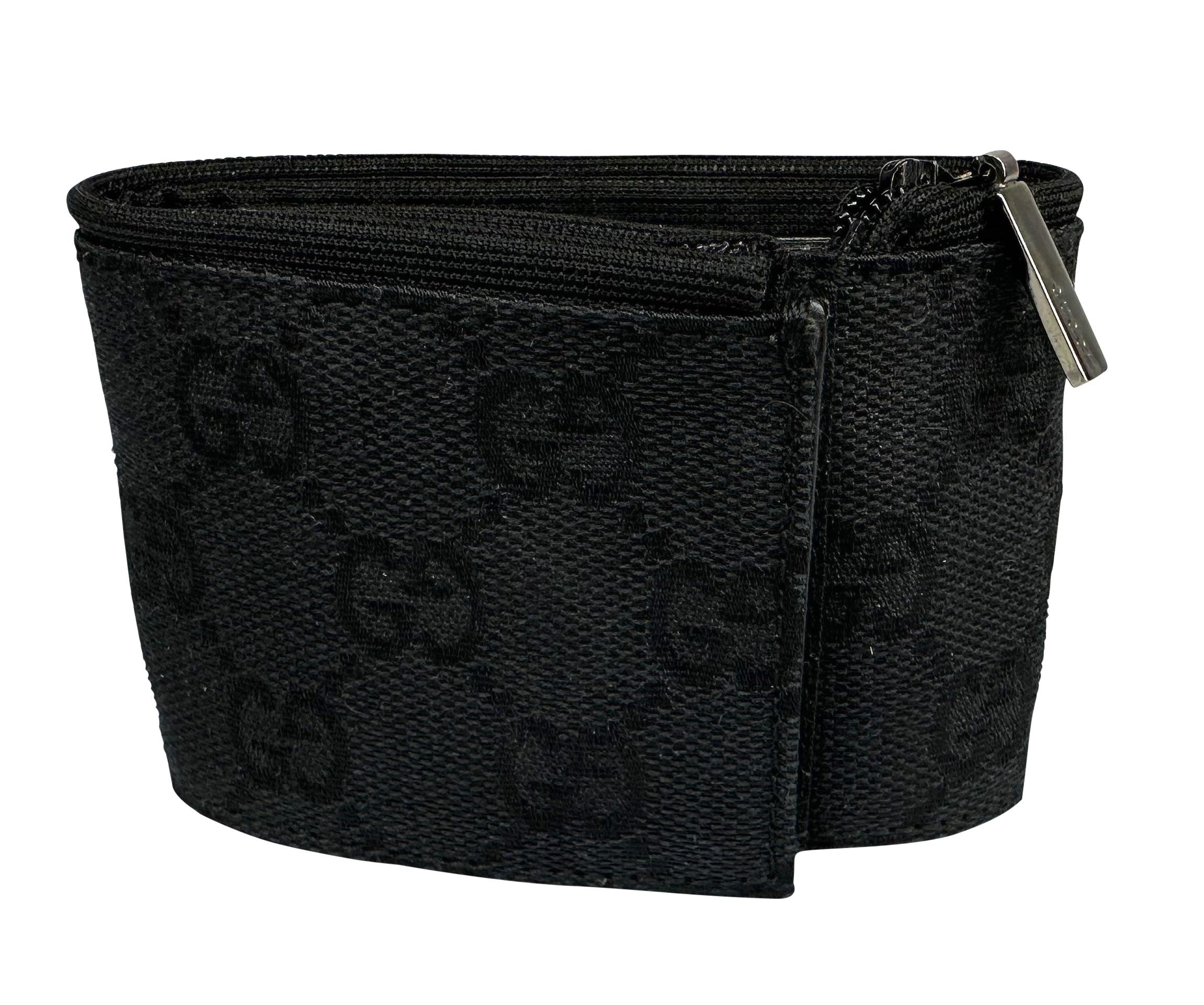 Presenting a black Gucci 'GG' monogram pouch cuff, designed by Tom Ford. From the early 2000s, this zip bracelet features a velcro closure and zip pocket just big enough to hold the absolute essentials, making it the perfect hands-free accessory.