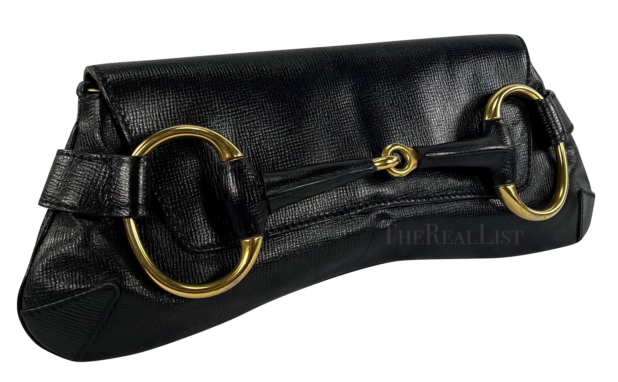 TheRealList presents: a fabulous black leather embossed Gucci horse bit clutch, designed by Tom Ford. From the early 2000s, the bag's horse bit-style silhouette, expertly crafted from exquisite leather, is adorned with a captivating flap and a
