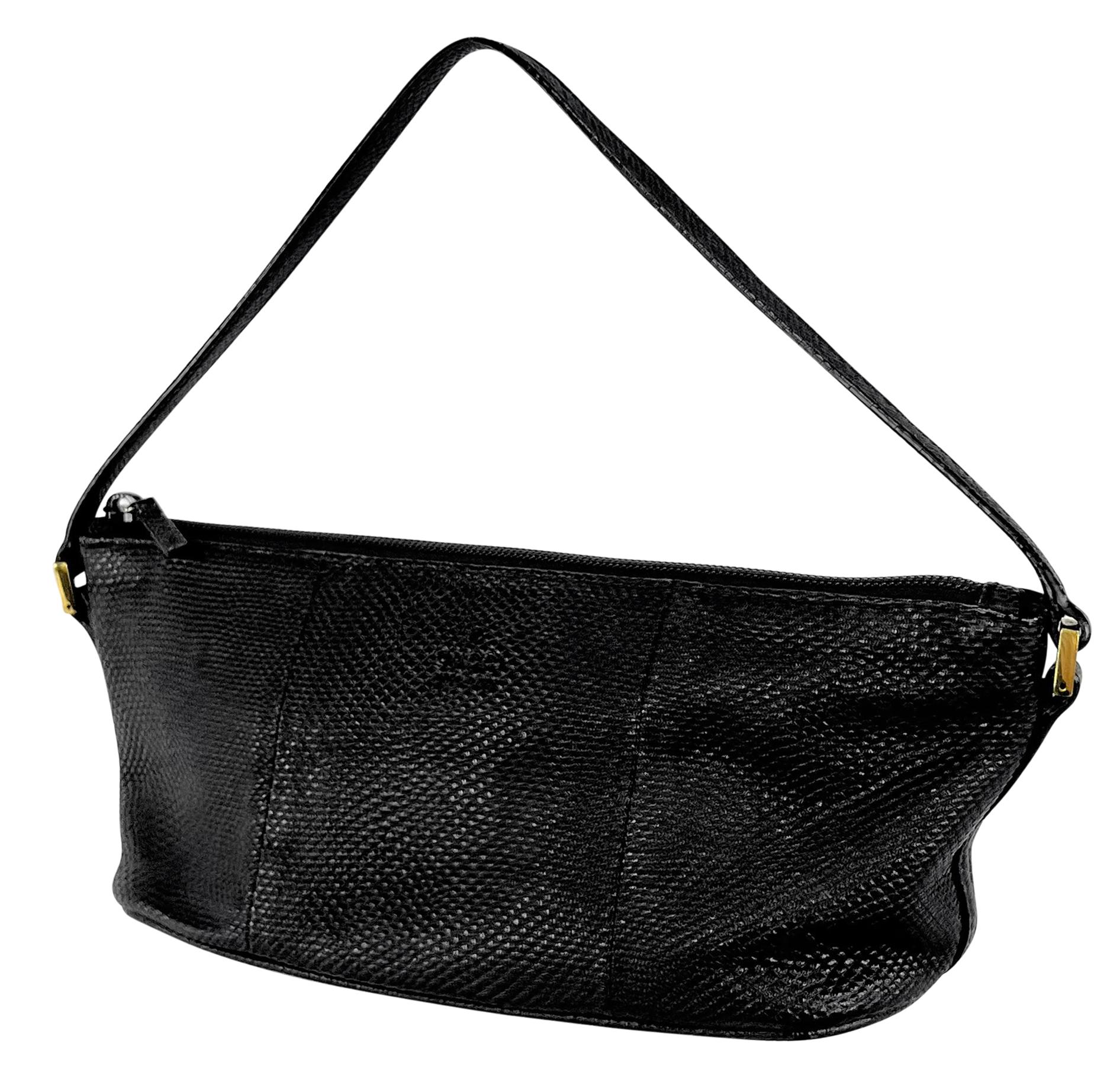From the early 2000s, this sleek black Gucci boat pochette, designed by Tom Ford is the perfect petite accessory. Crafted entirely from luxurious karung snakeskin, it is accented with petite gold-tone hardware.

Approximate measurements:
Height: