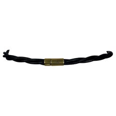Cintura anni 2000 Gucci by Tom Ford in pelle nera intrecciata con tonalità oro