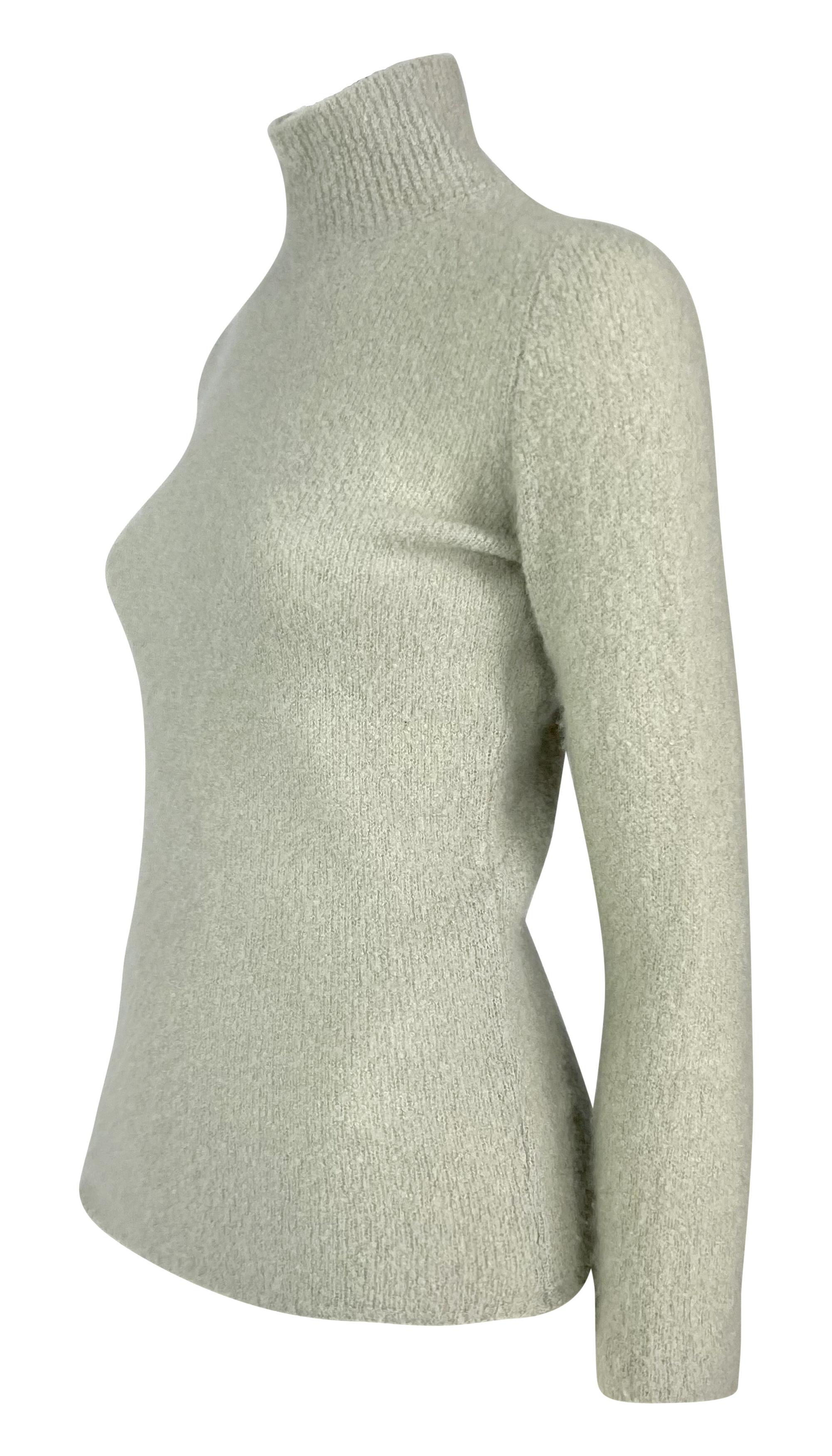 This late 1990s Tom Ford for Gucci turtleneck sweater in soft blue features a slim fit, cozy textured knit, and a mock neck.

Approximate measurements:
Size - M
Shoulder to hem: 23.5