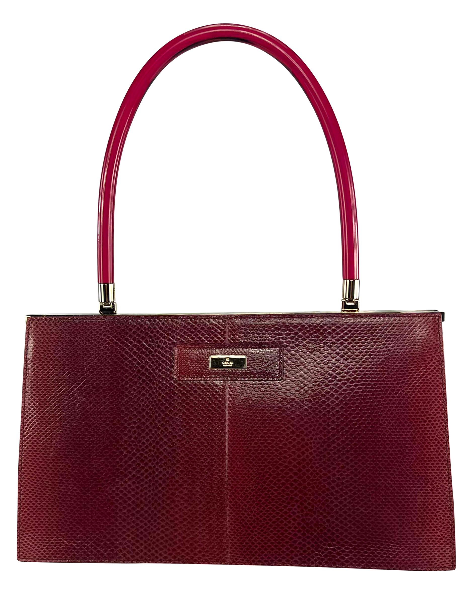 This rare deep red Gucci bag from the early 2000s is crafted from dyed Karung snakeskin and finished with gold-tone hardware and a sculptural red lucite handle. 

Approximate Measurements:
Length: 12
