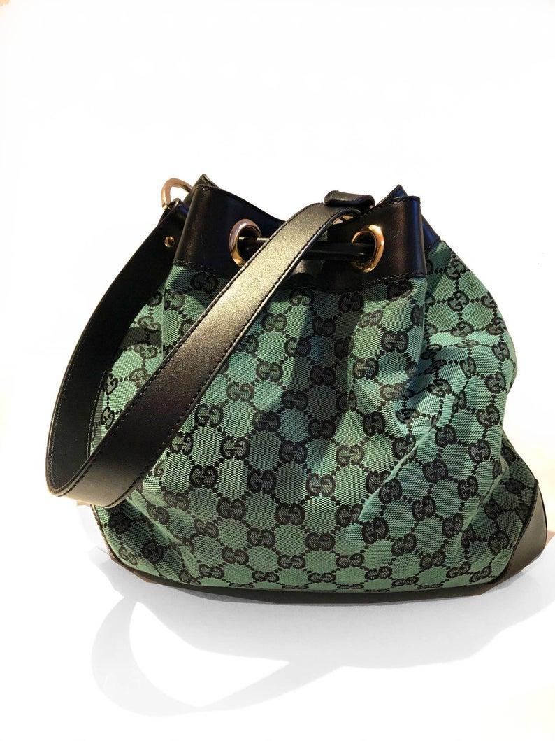 FREE UK and WORLDWIDE DELIVERY 

Stunning and rare vintage GUCCI green fabric bucket bag, GG monogram pattern detail, condition is like new, no rips, smells or faults, siege drawstring, medium weight metal work, black leather details, leather