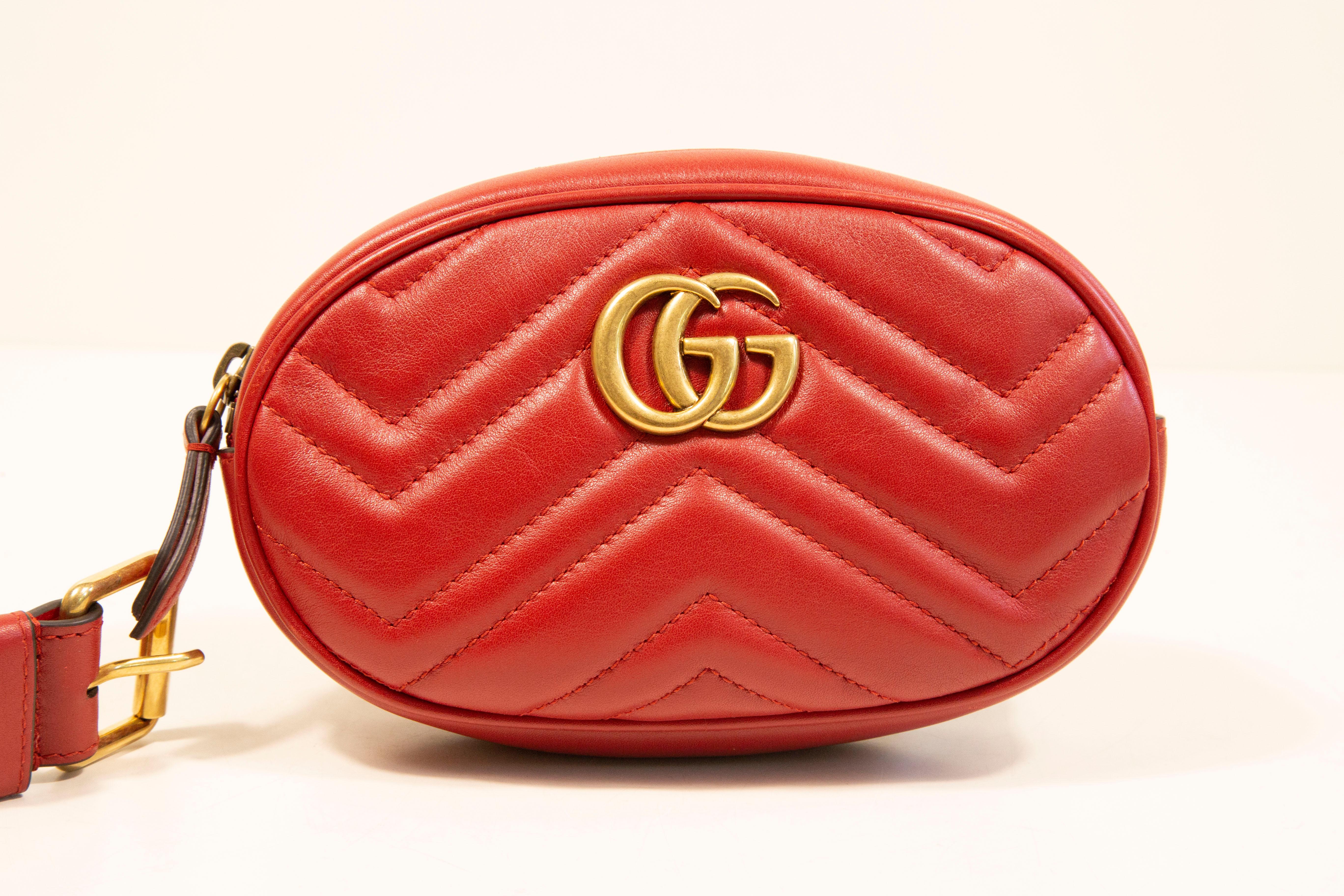 Gucci Marmont oval belt bag.  The bag features a quilted Matelasse red leather exterior and gold-tone hardware. The belt is detachable and has its size is 34