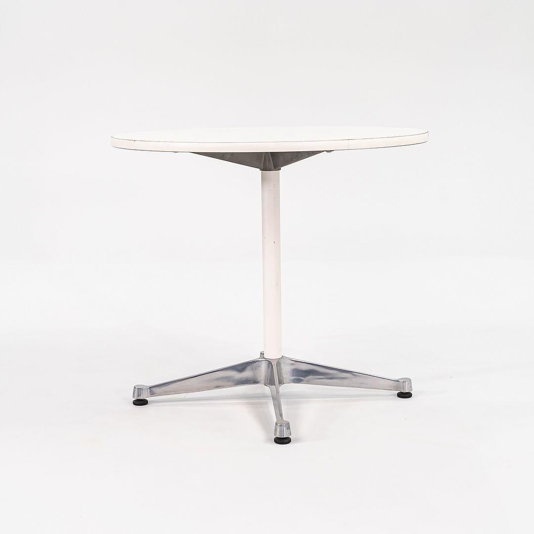 This is an Eames Contract Base Table, originally designed by Ray and Charles Eames in 1957. This particular example was produced by Herman Miller in the USA in the 2000s. The table is comprised of an aluminum base with a white laminate top. 

The