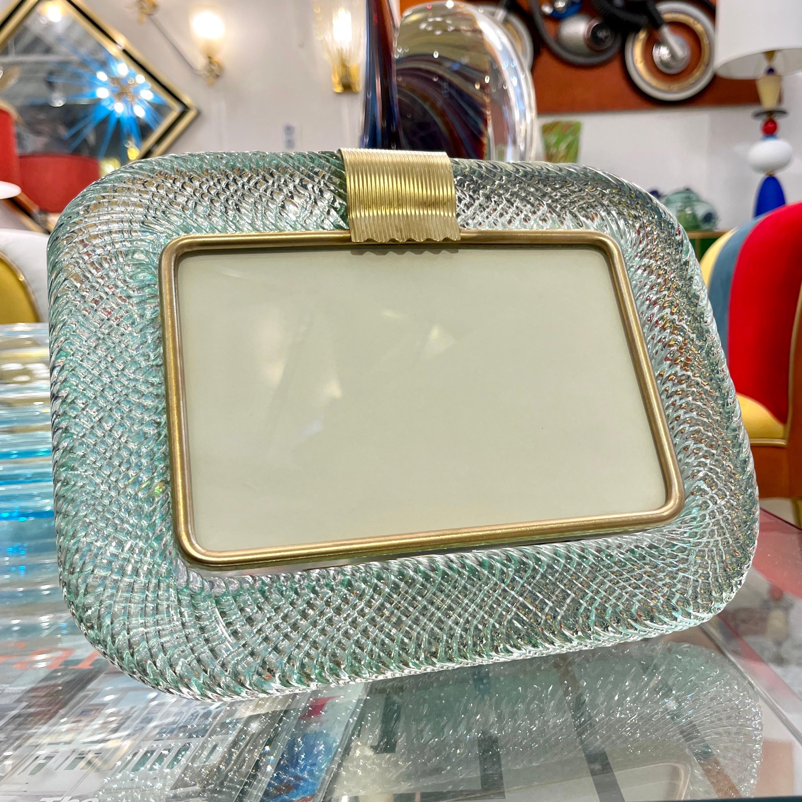 A sophisticated Venetian modern design horizontal photo frame in thick blown Murano glass worked in a luscious Fontana Arte sky blue jewel color, by Barovier Toso, signed piece. The elegant texture of the tightly twisted glass frame in the Torchon