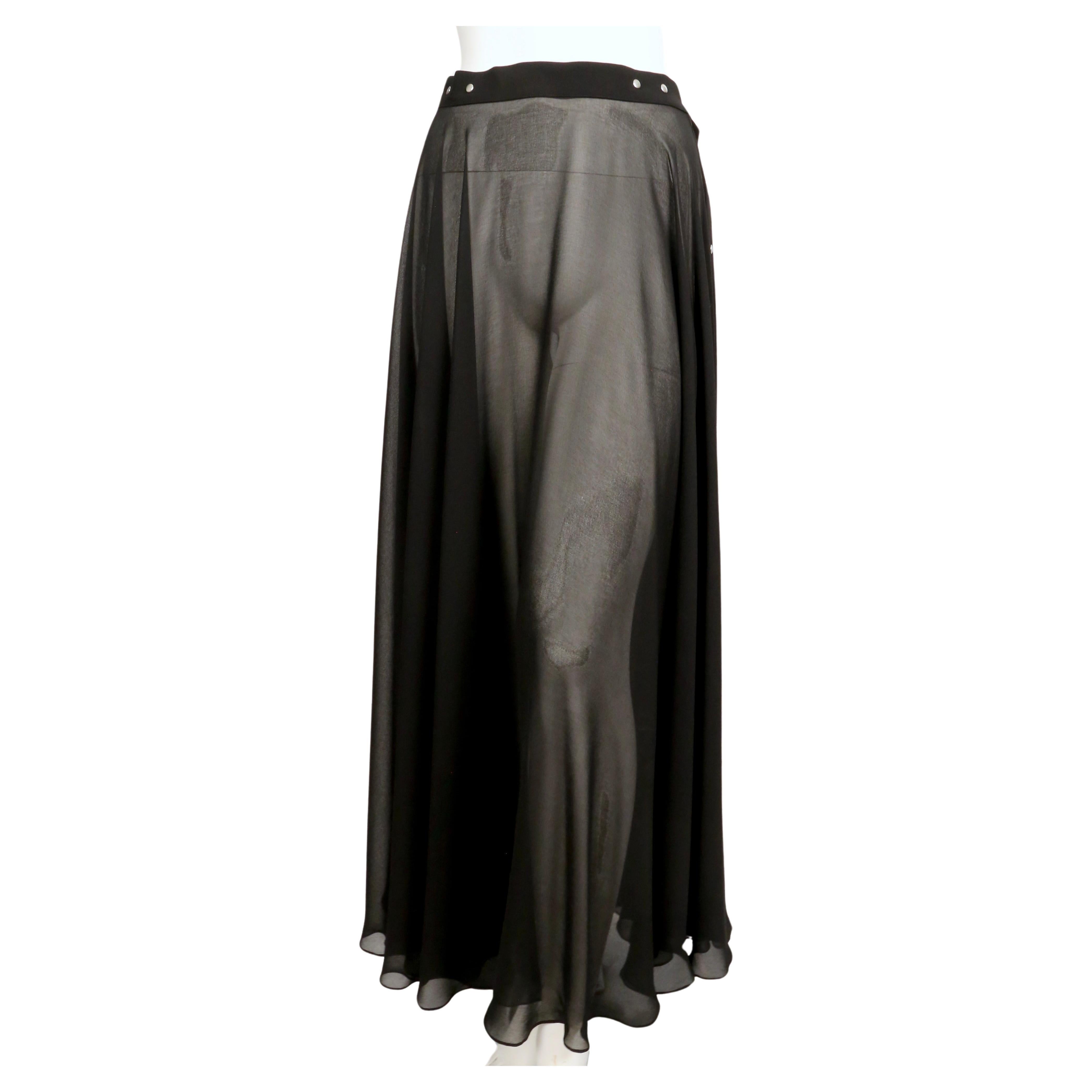 Black sheer maxi skirt with silver snap closure designed by Jean Paul Gaultier dating to the late 1990's. Fabric has a beautiful drape. No size label. Approximate measurements: waist 28.5