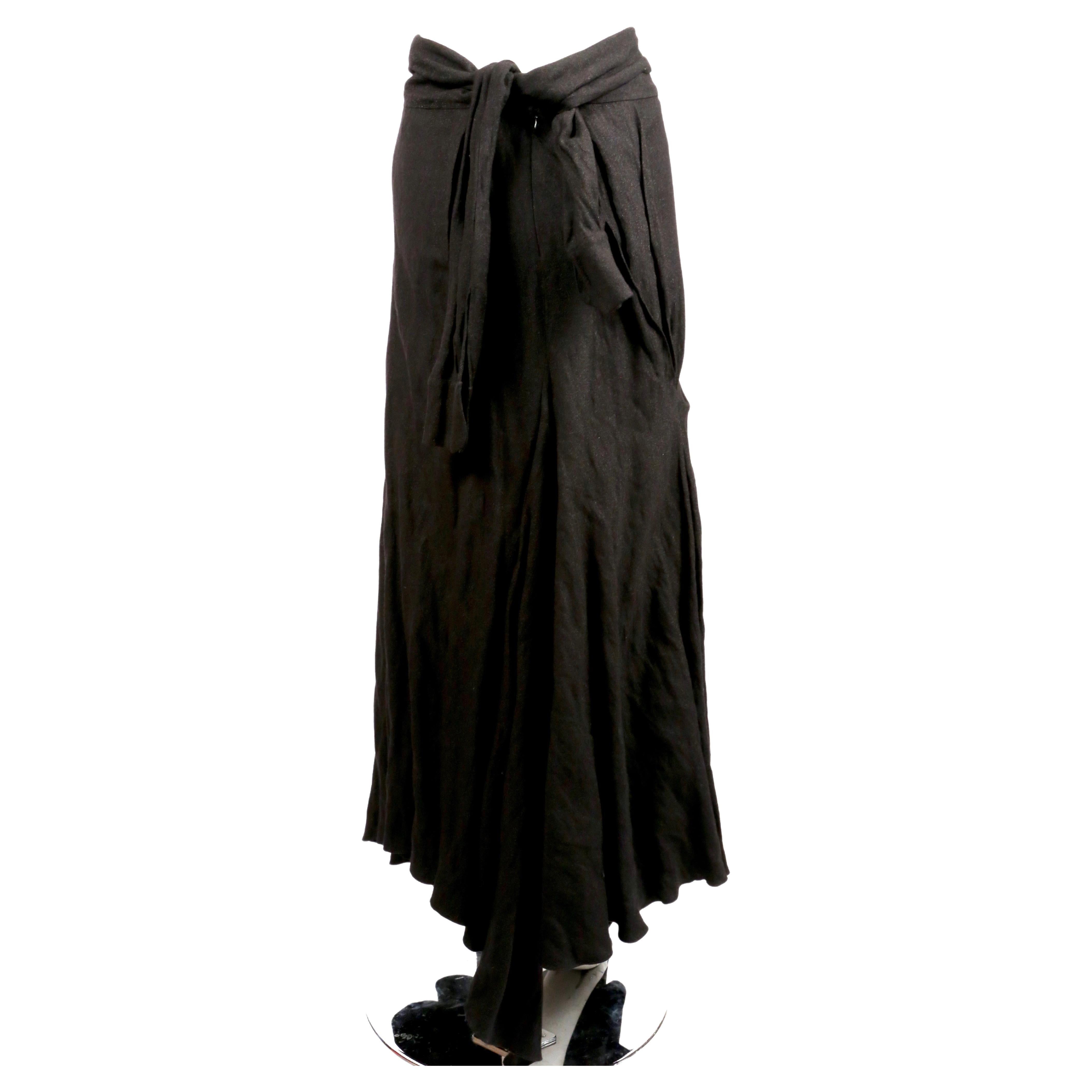 Jupe longue drapée d'un noir tendre, dotée d'un lien unique à l'arrière de la taille, conçu par John Galliano au début des années 2000. La jupe est très souple lorsque vous marchez. Taille française 38. Mesures approximatives : taille 29