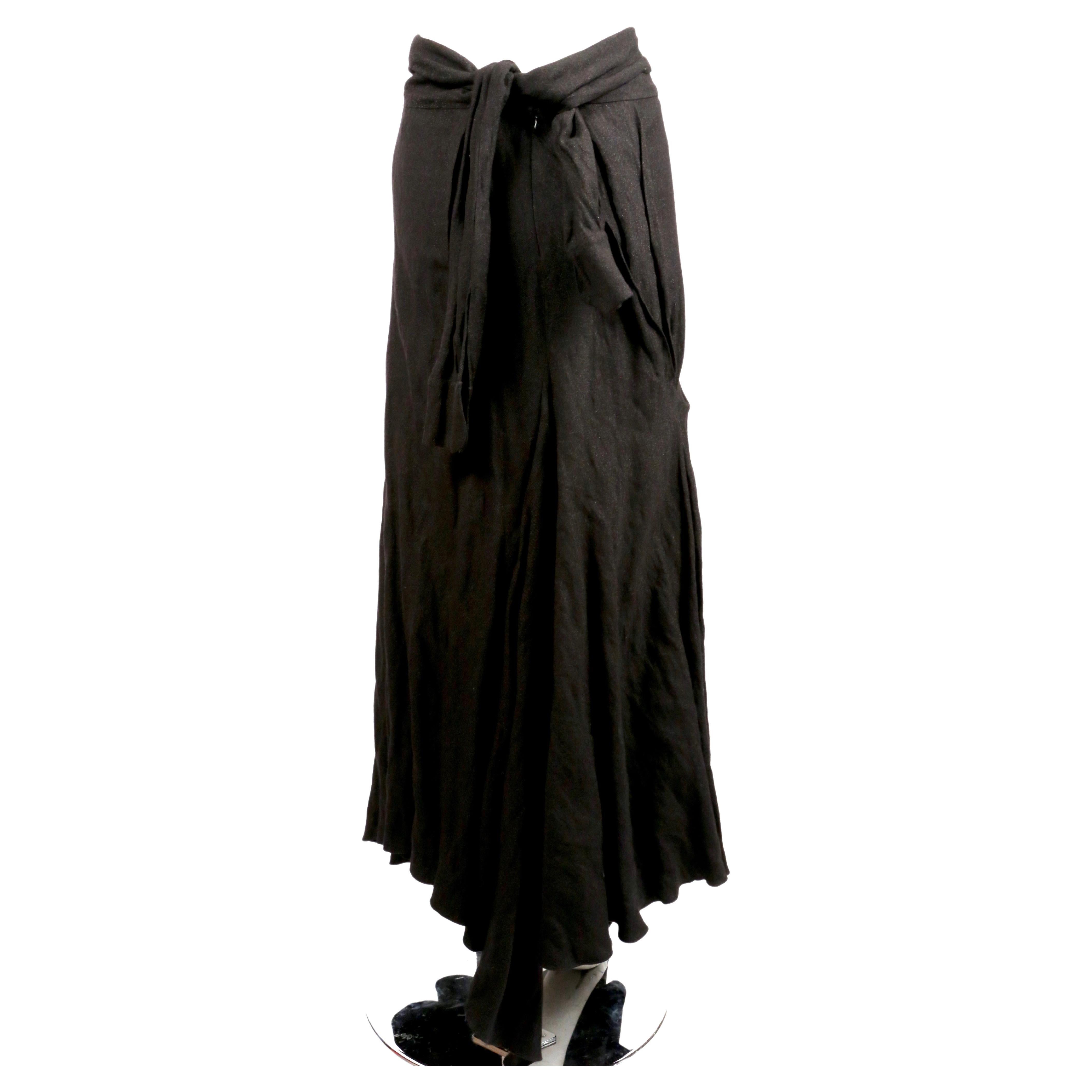 Soft-black, draped maxi skirt with unique 'shirt-sleeve' ties at back of waist designed by John Galliano dating to the early 2000's. Skirt has great movement when you walk and has a slight sparkle to the fabric. French size 38. Approximate