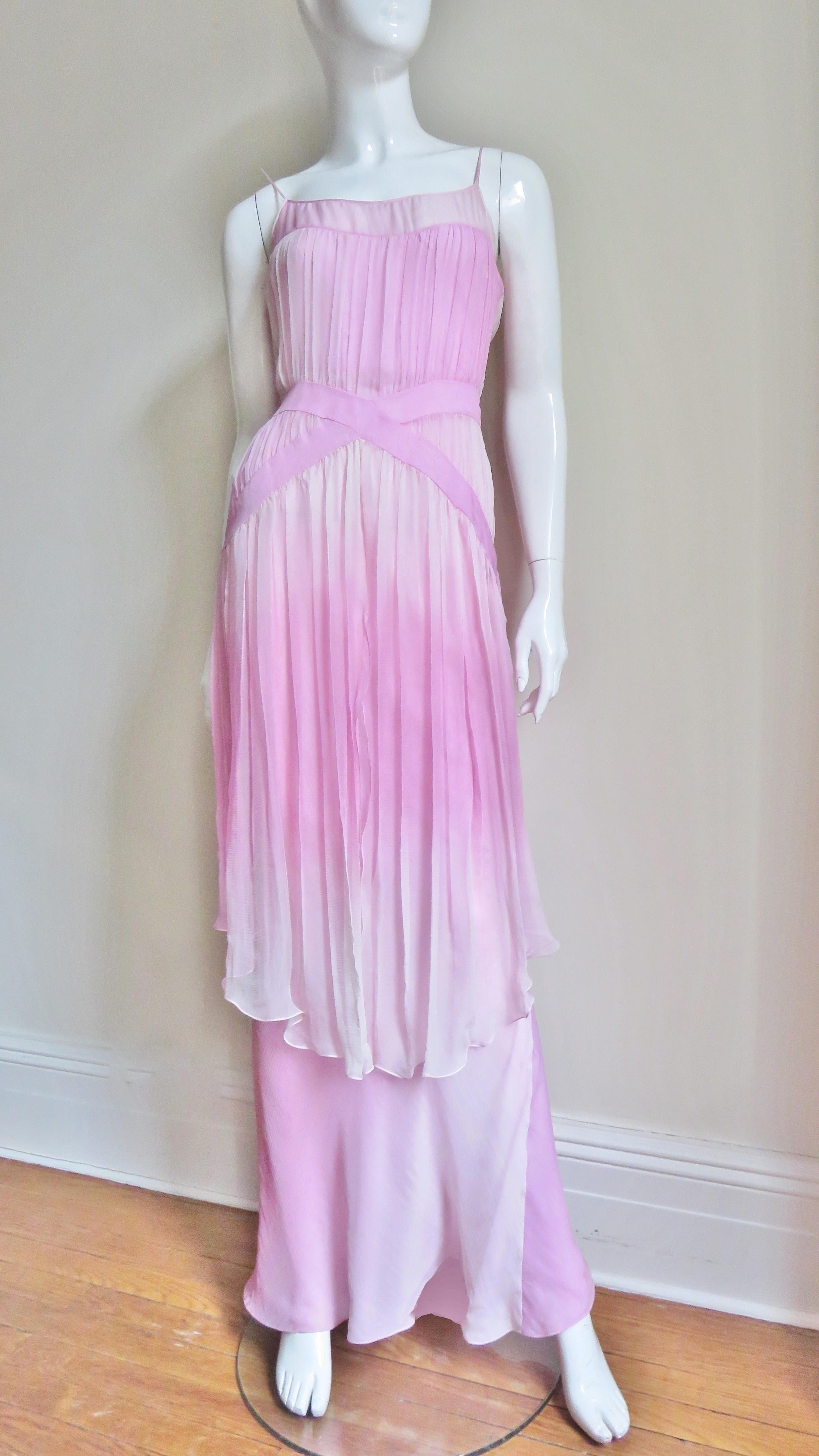 A gorgeous John Galliano silk ombre gown in shades of pink.  Spaghetti straps emanate from a small sheer band around the top of the bodice.  From here a layer of silk gathers onto 2 angled crossing bands at the waistline then continues forming an