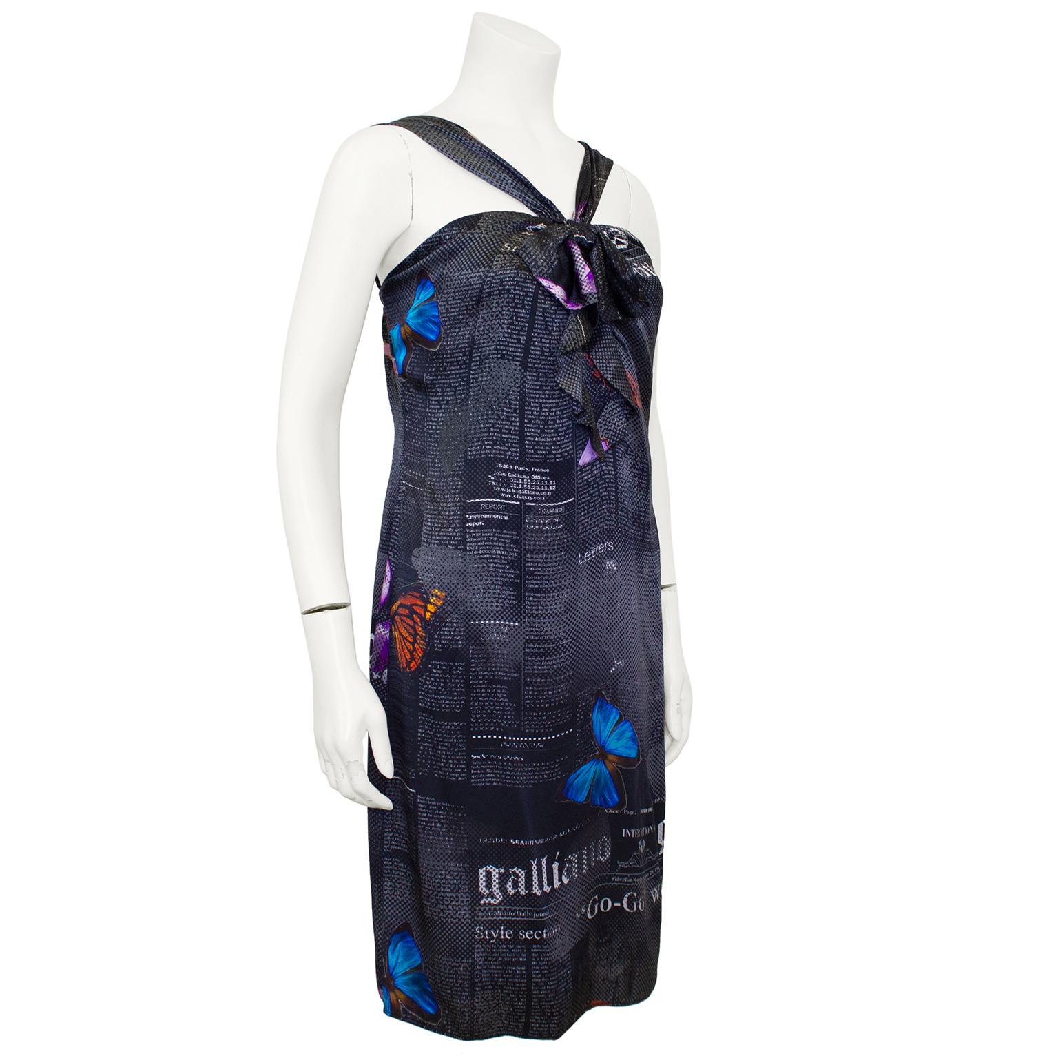 A very pretty modified version of the iconic newsprint dress, this Galliano newsprint and butterfly dress is from the mid 2000s. Black silk with all over small newsprint that fades into a polka dot print with large colorful butterflies. V neck
