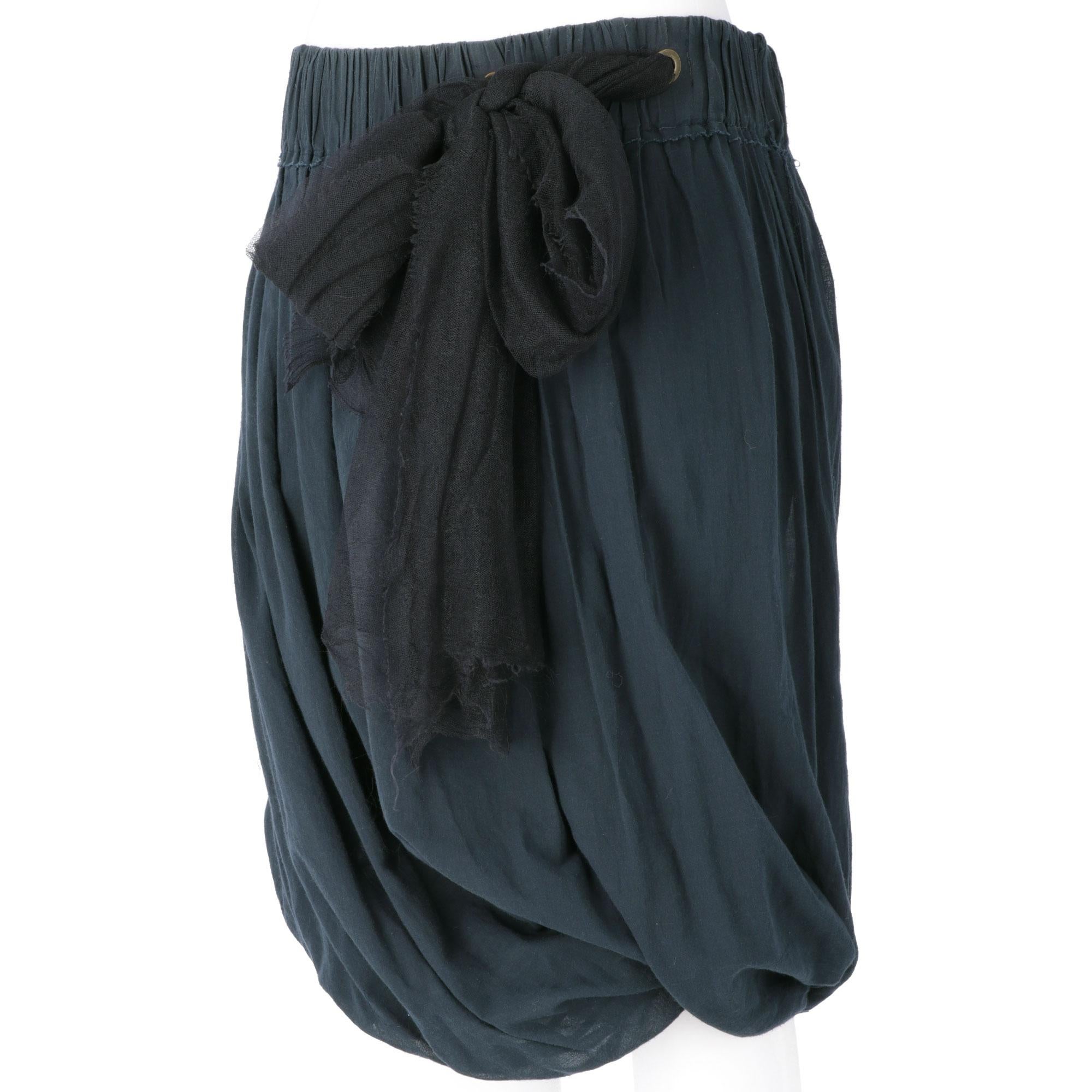 Lanvin blue petroleum cotton knee-length skirt, with a high-waisted, 
balloon shape with drapery, elastic waistband and large bow in black tulle. Lined.
Years: Sumer 2006

Made in France

Size: 38 FR

Linear measures

Height: 65 cm
Waist: 41 cm
