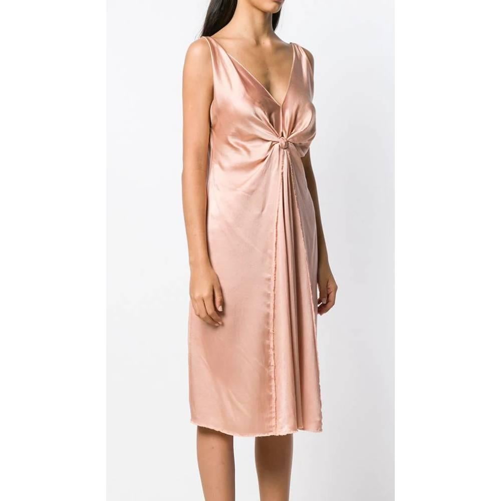 Lanvin pink silk dress below the knee, V-neckline, decorative front node with curled fabric.
Year: Summer 2004

Made in France

Size: 40 FR

Linear measures

Height: 105 cm 
Bust: 43 cm
Waist: 48 cm
Hips: 64 cm