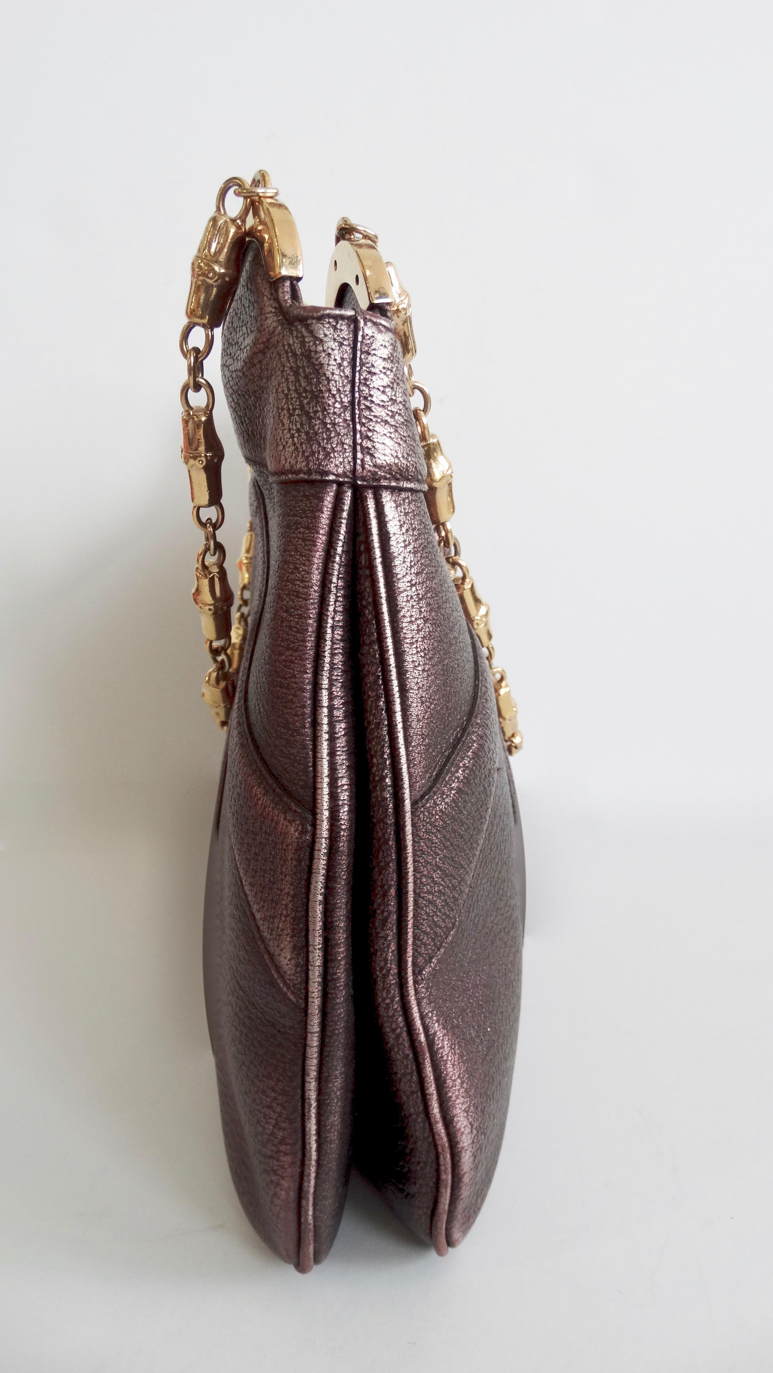 Walk around with a piece of Gucci fashion history! Circa 2000s, this gorgeous metallic purple leather shoulder bag is from the infamous Tom Ford for Gucci era and features gold toned hardware throughout. Includes leather crafted detailing, a snap