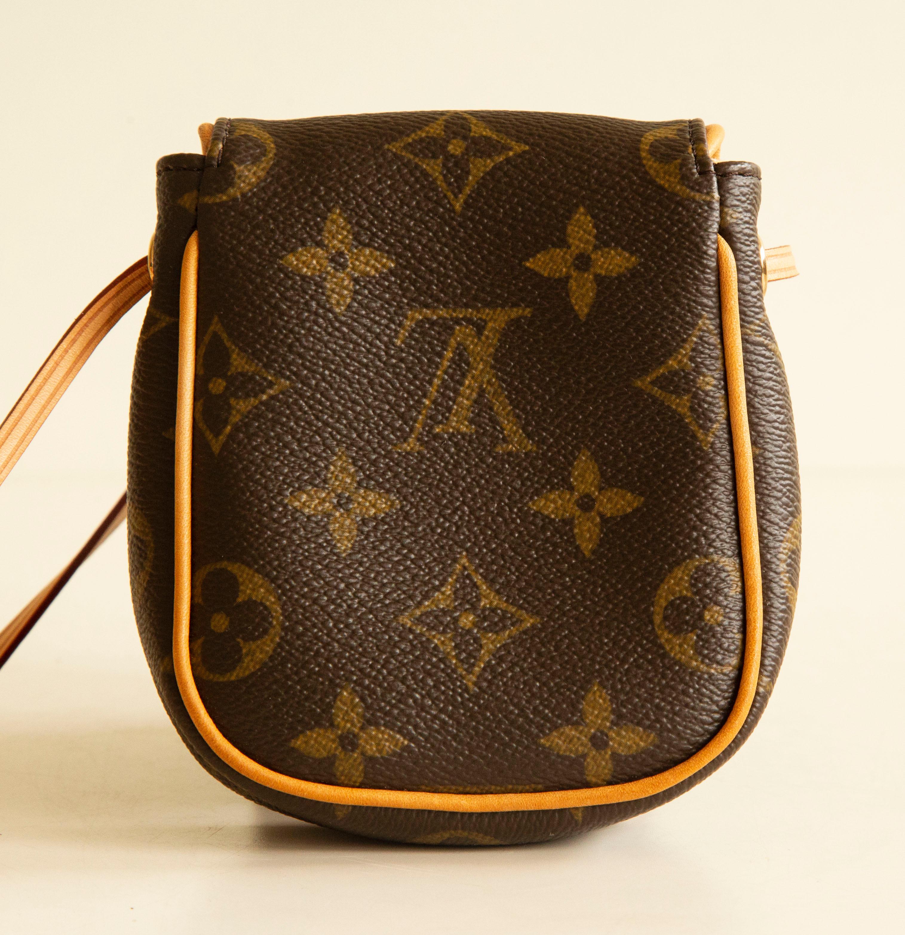 A Louis Vuitton Can Cun crossbody mini bag. The bag features a brown LV monogram canvas, tan leather trim, and gold-tone hardware. The interior is lined with beige suede and is neat &clean. The bag has no notable flaws to be mentioned and is in