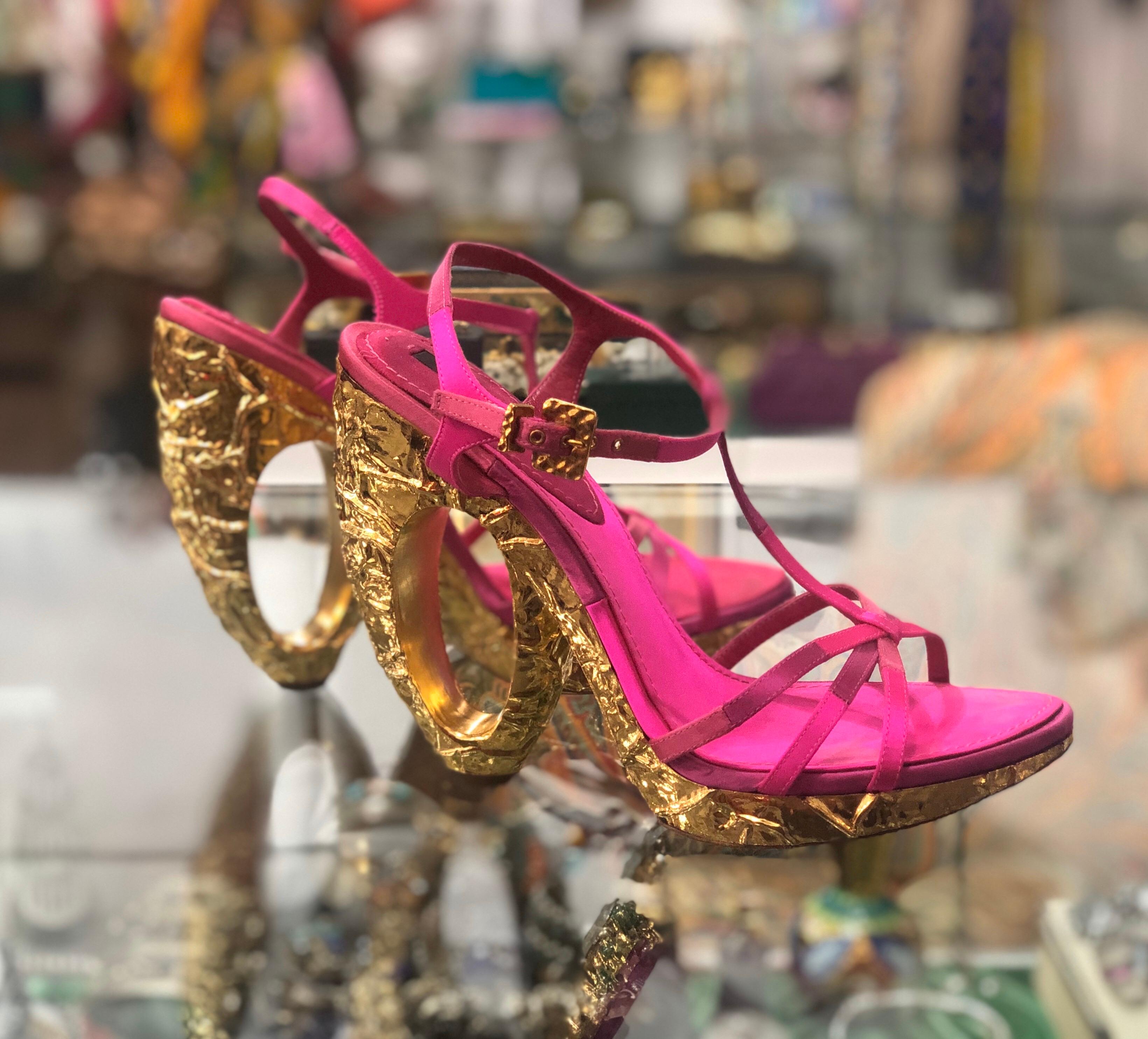 Looking to make a statement? Well the perfect shoes have arrived! Circa recent 2000s, these Louis Vuitton fuchsia satin heels feature various hues of fuchsia on the straps and a sculpted heel with a crushed textured gold finish. A true showstopper,