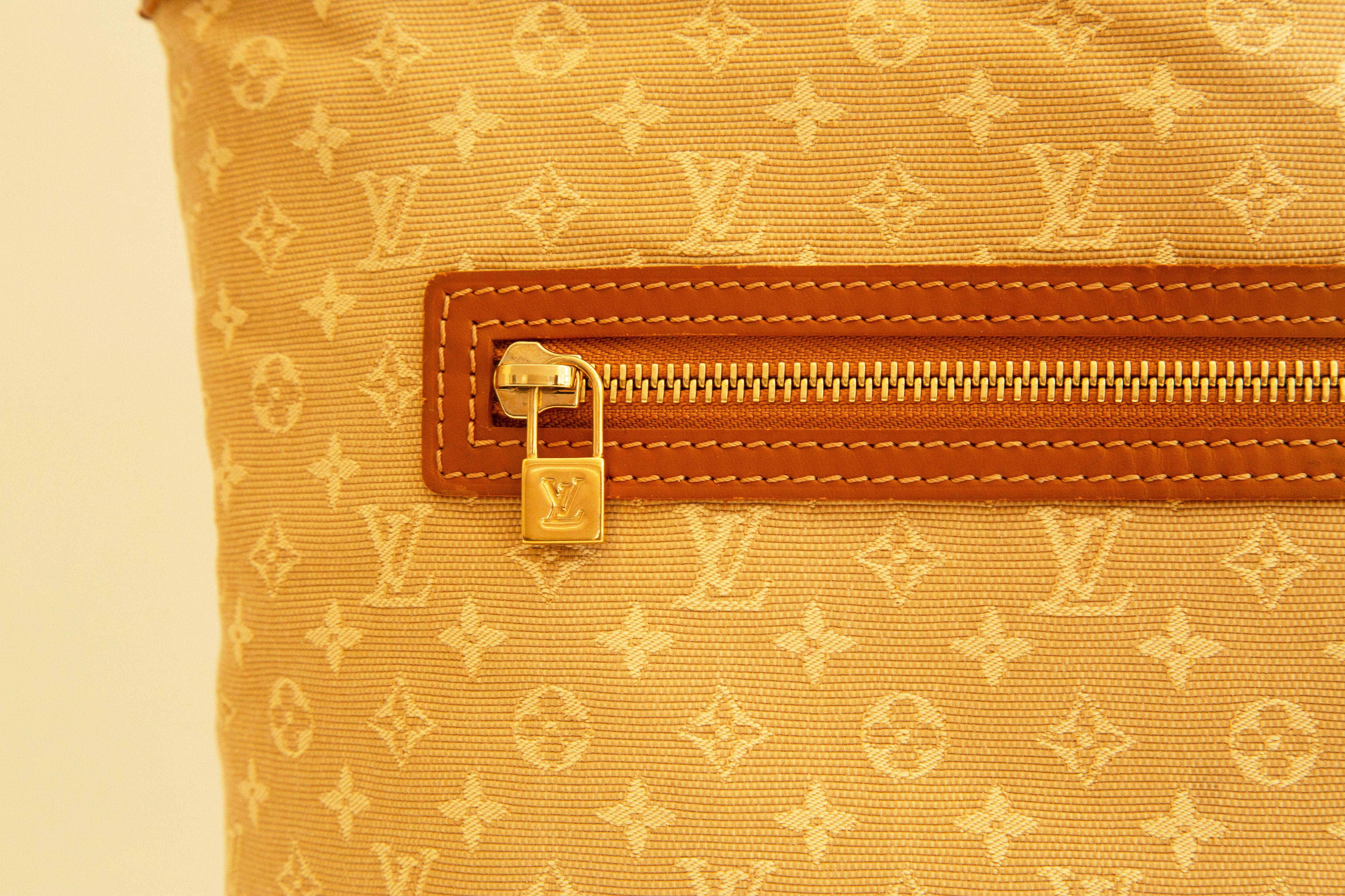 A rare  Louis Vuitton Lucille Monogram tote/shoulder bag. The bag is made of idylle monogram canvas, with Vachetta leather trim with gold toned hardware. 
The interior is lined with beige fabric and leather. It consists of one major compartment, 4