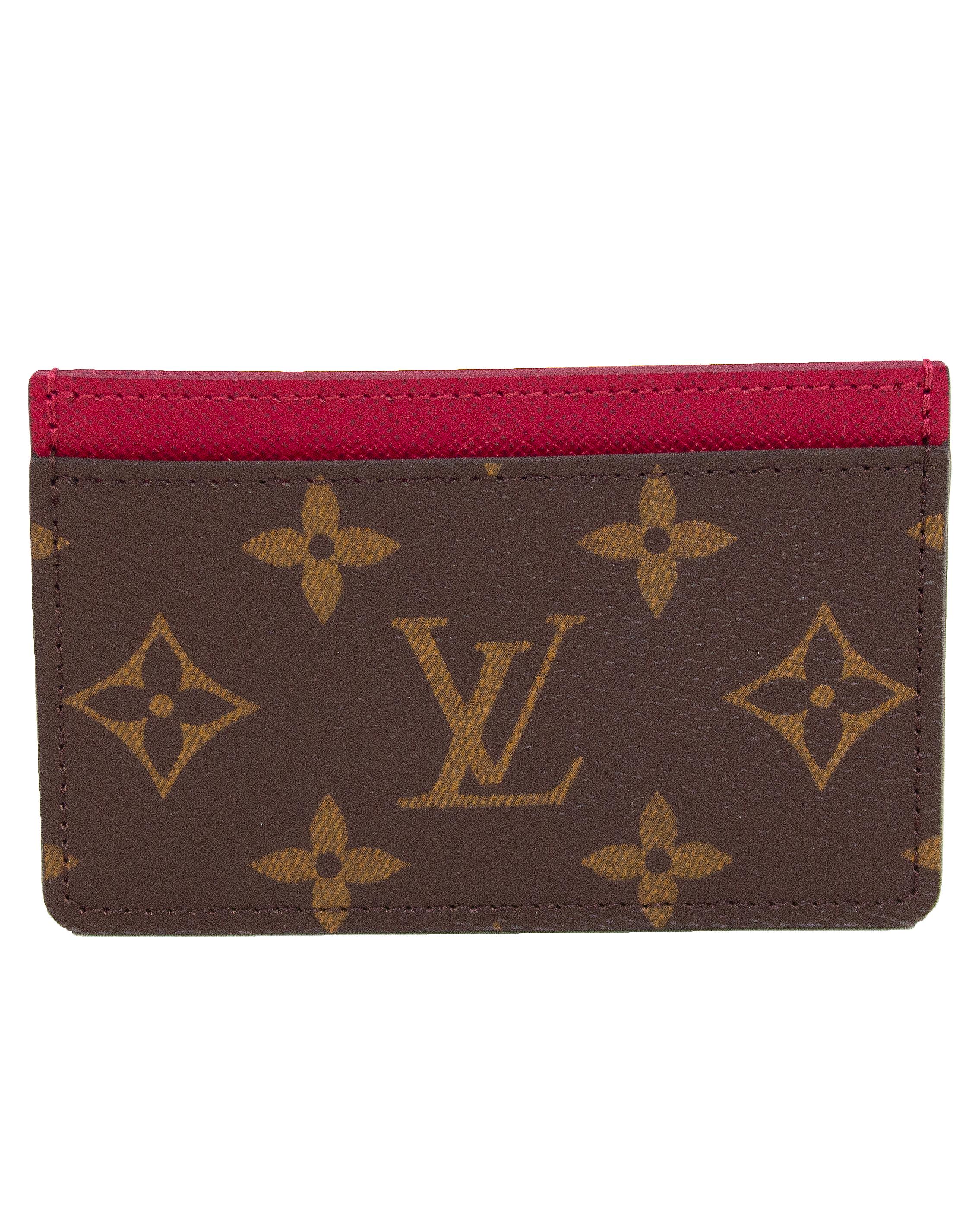 Louis Vuitton monogram card case with raspberry accent interior from the 2000s. In excellent condition with matching dust sleeve, the perfect, timeless accessory. 

4.5