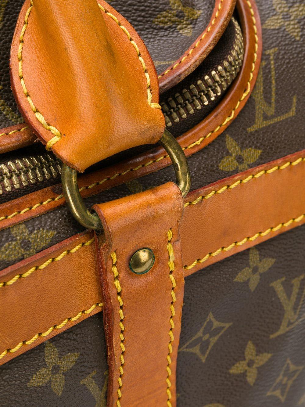 Brown leather monogram travel bag from Louis Vuitton Vintage featuring a monogram print, a structured design, a rectangular body, round top handles, leather trims, a hanging luggage tag, stitching details, a foldover top, an all around zip fastening