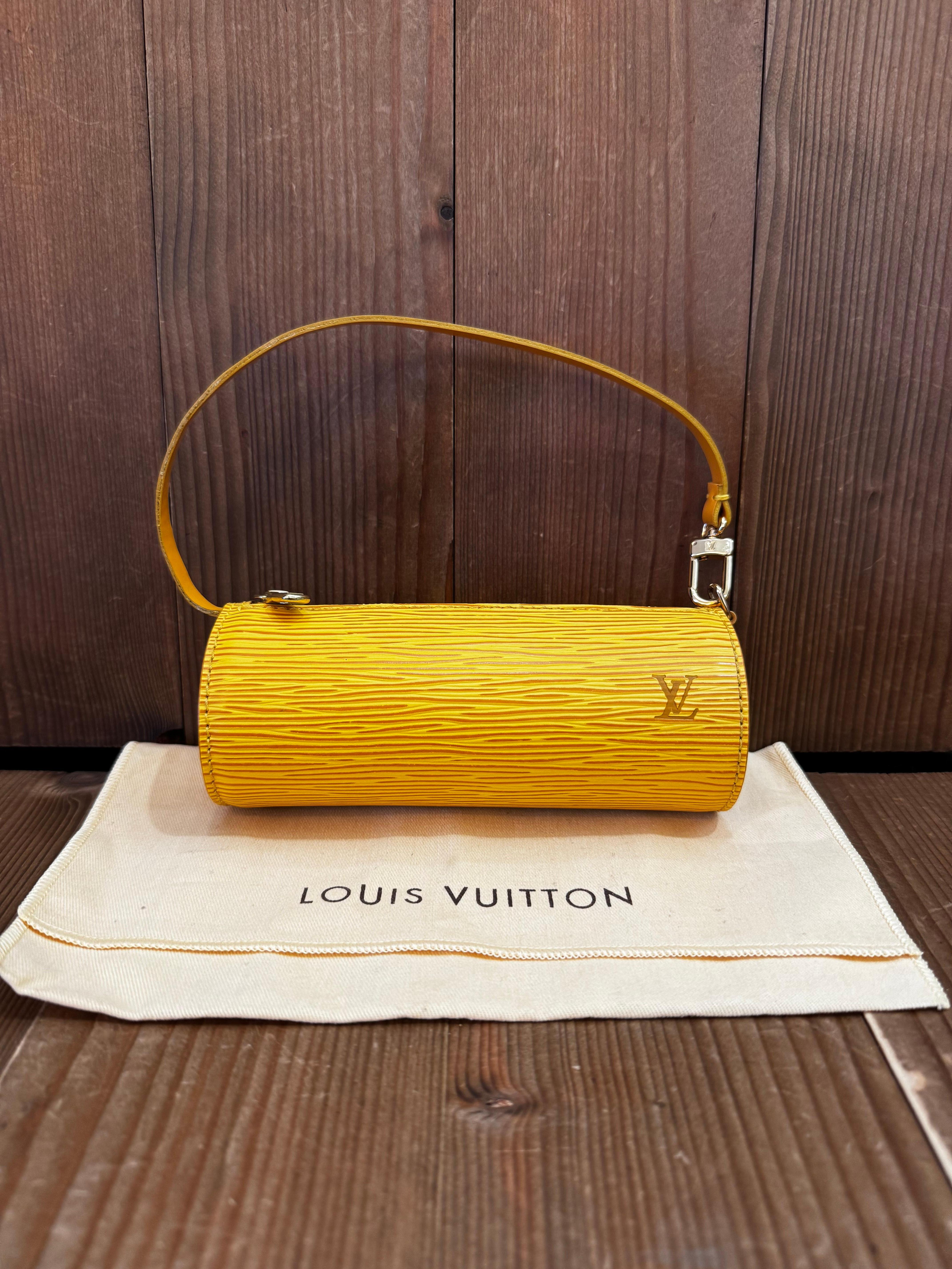 This vintage LOUIS VUITTON mini Papillon pouch is crafted of Louis Vuitton’s epi leather in yellow and gold toned hardware. Top brass zipper closure opens to a felt interior in purple. Made in France with datecode MI0063. Measures 6”x 2.25”x 2.25”.
