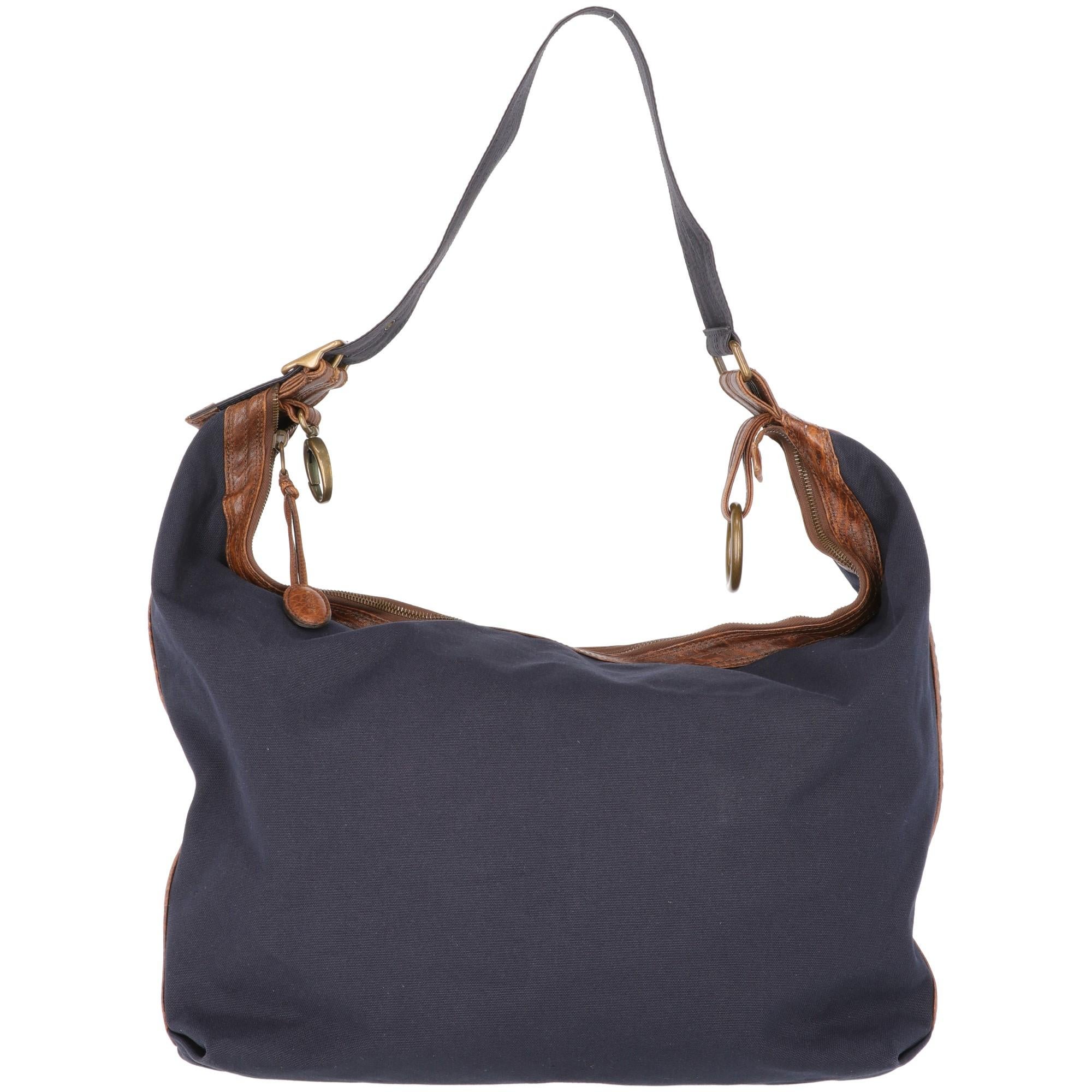 Marni blu and brown bag. Cotton and leather inserts. Adjustable handle with metal buckle. Zip closure. Zipped internal pocket. The item could be used both as a shoulderbag or as an handbag.

Width: 44 cm
Height: 39 cm
Handle: 58 cm

Product code: