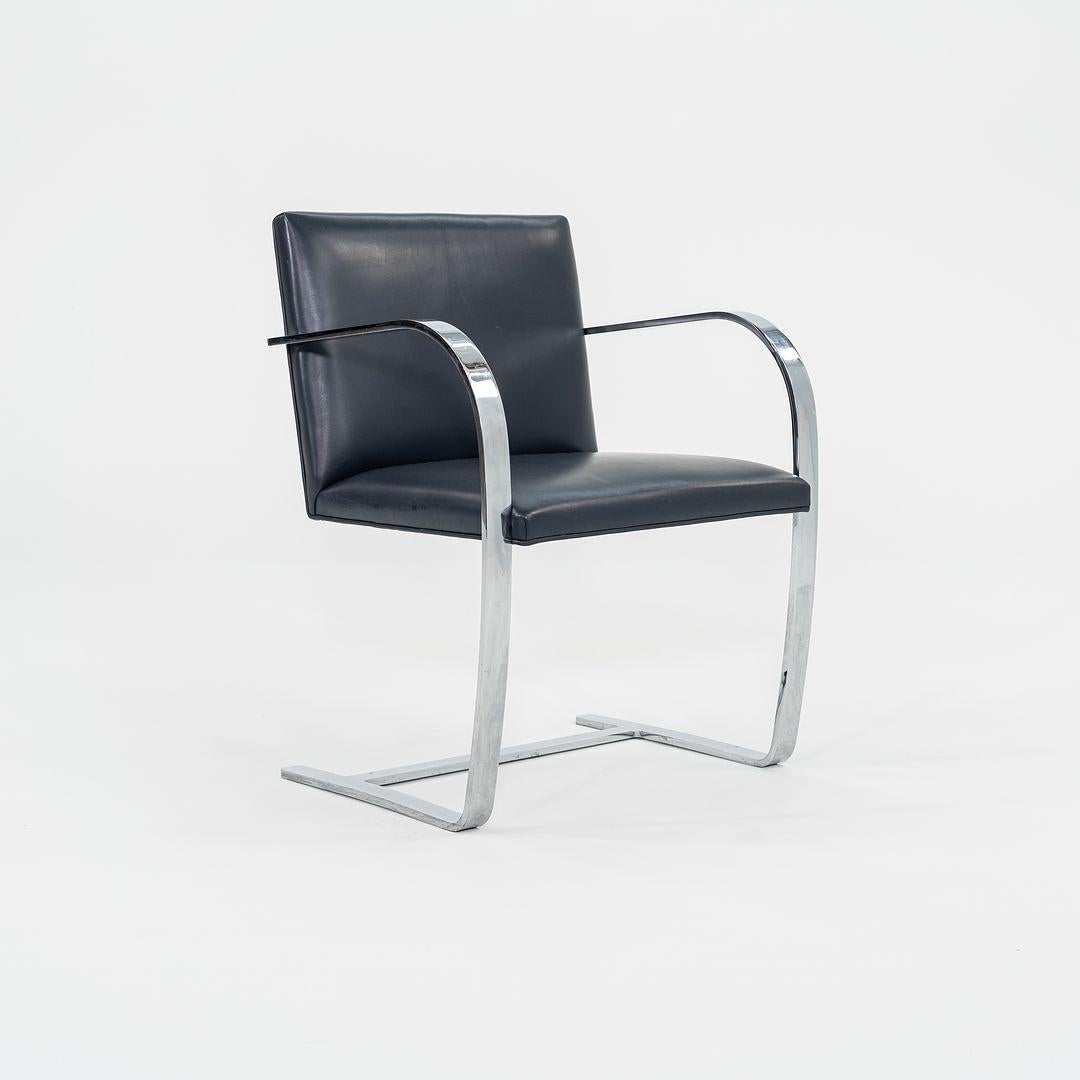 This is a Flat Bar Brno Armchair, Model 255, initially designed by Mies van der Rohe in 1930. These examples were manufactured by Knoll in the 2000s, and the listed price includes one chair. We have several of these pieces available for purchase in