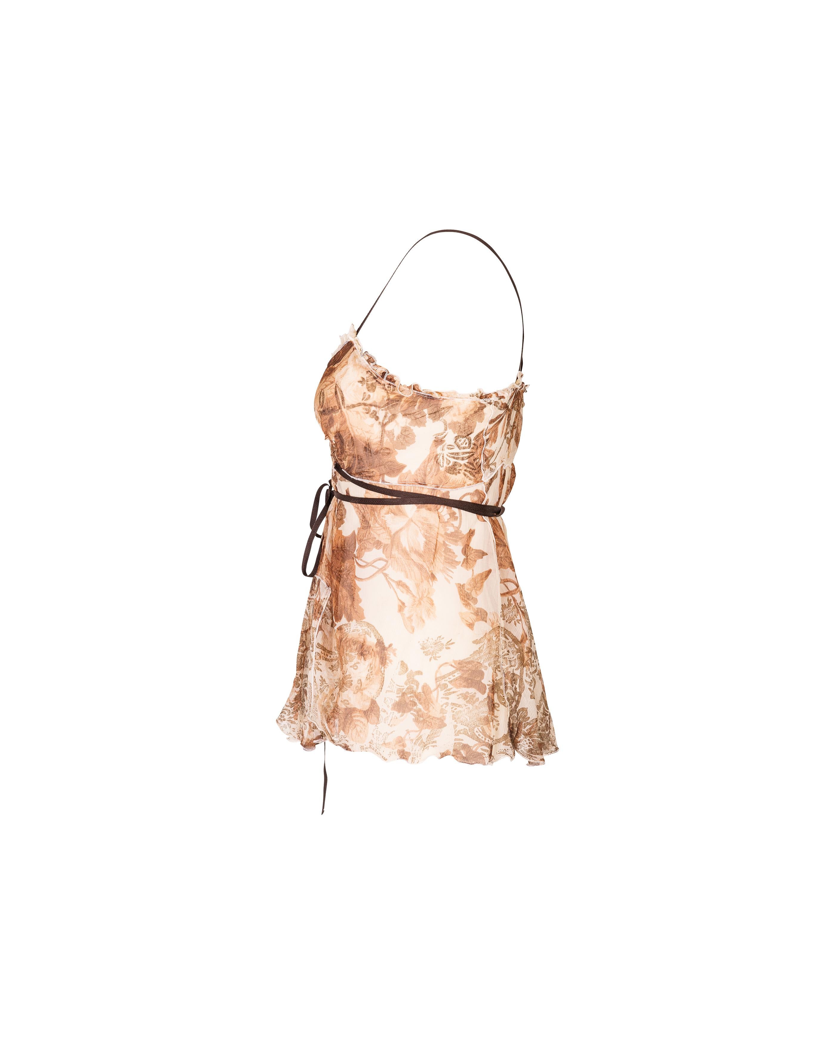 2000's Miu Miu by Miuccia Prada printed brown and cream tank top. Signature 2000's style floral print throughout. Features ruffle details, cross-back straps and sash-tie closure around waist.