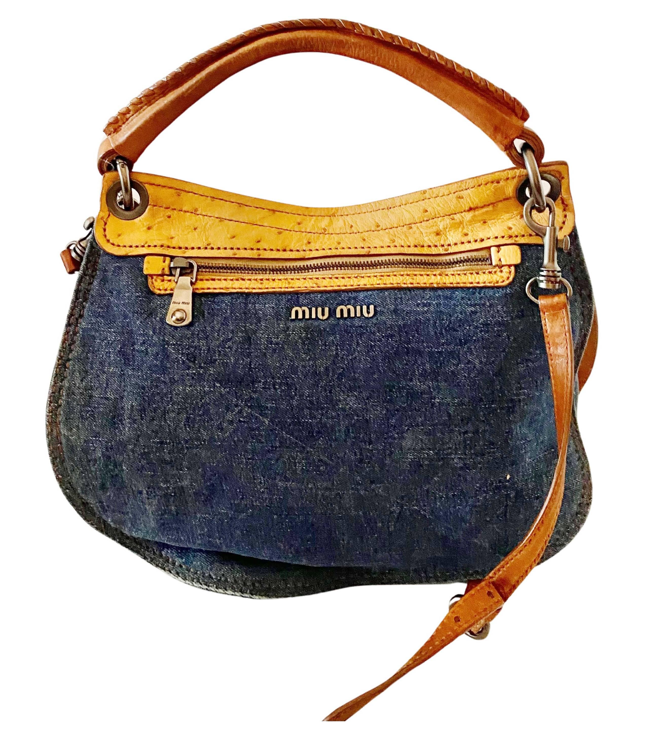 2000s miu miu leather and denim top handle Flap Bag, Ostrich pattern leather flap which contrasts with the denim. Small handle and detachable long handle. Detachable purse inside bag with Miu Miu zip and plaque.

Condition: Some small marks on flap