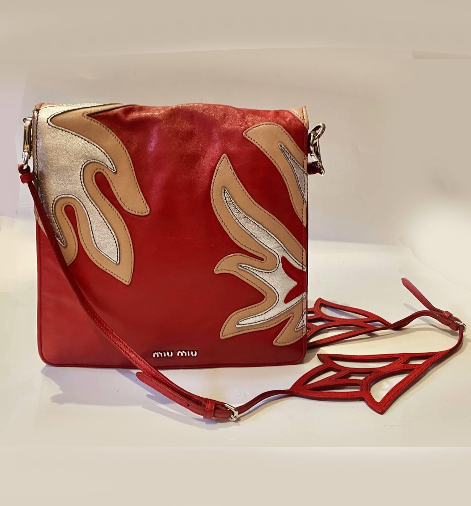2000's miu miu shoulder bag, very soft, mainly red with black, silver and beige flower deco, cutout flower detail to detachable shoulder strap, 3 sections plus internal zip, silver metalware, Made in Italy  This luxury piece is the perfect blend of