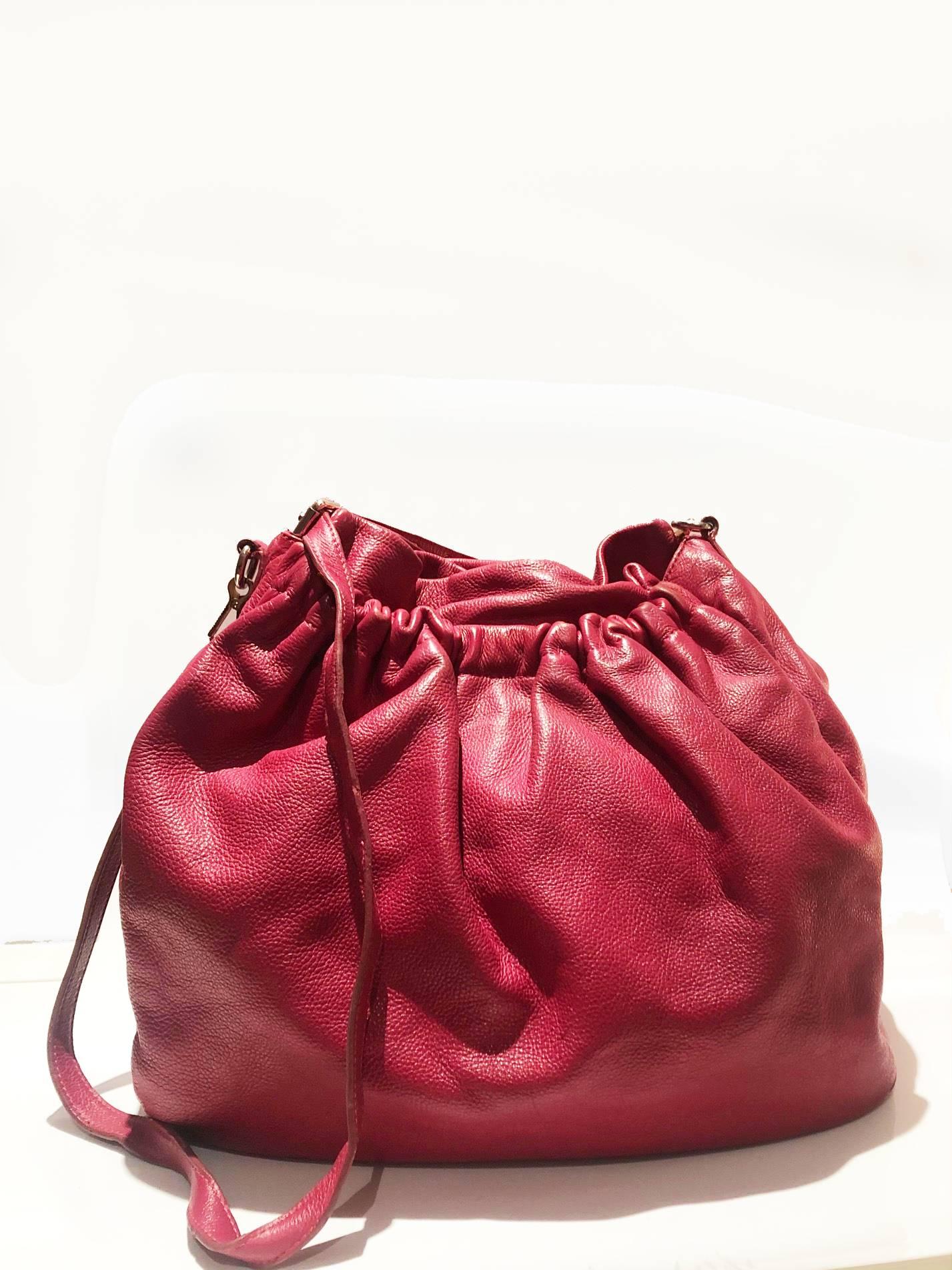 Miu Miu strawberry pink oversized slouch leather hobo bag, double inside compartments, gold-tone hardware, metal lettering logo on the side, snap closure, cotton purple satin lining with zipper pocket and patch pocket

Condition: good, 2000s, some
