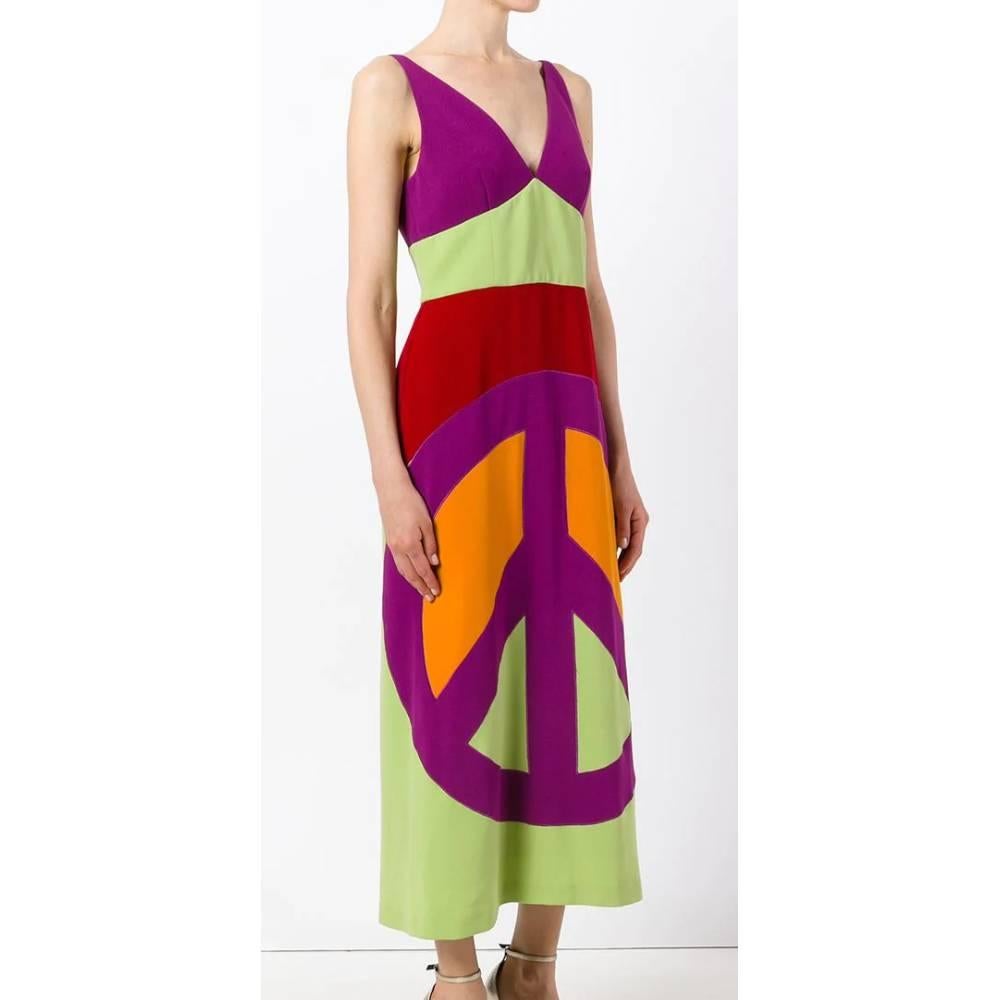 Moschino long multicolored dress with large peace symbol printed on the length of the skirt. V-neck and sleeveless, back closure with hidden zip. Ankle length.
Years: 2000s

Size: 42 IT

Linear measures

Height: 130 cm
Bust: 42 cm