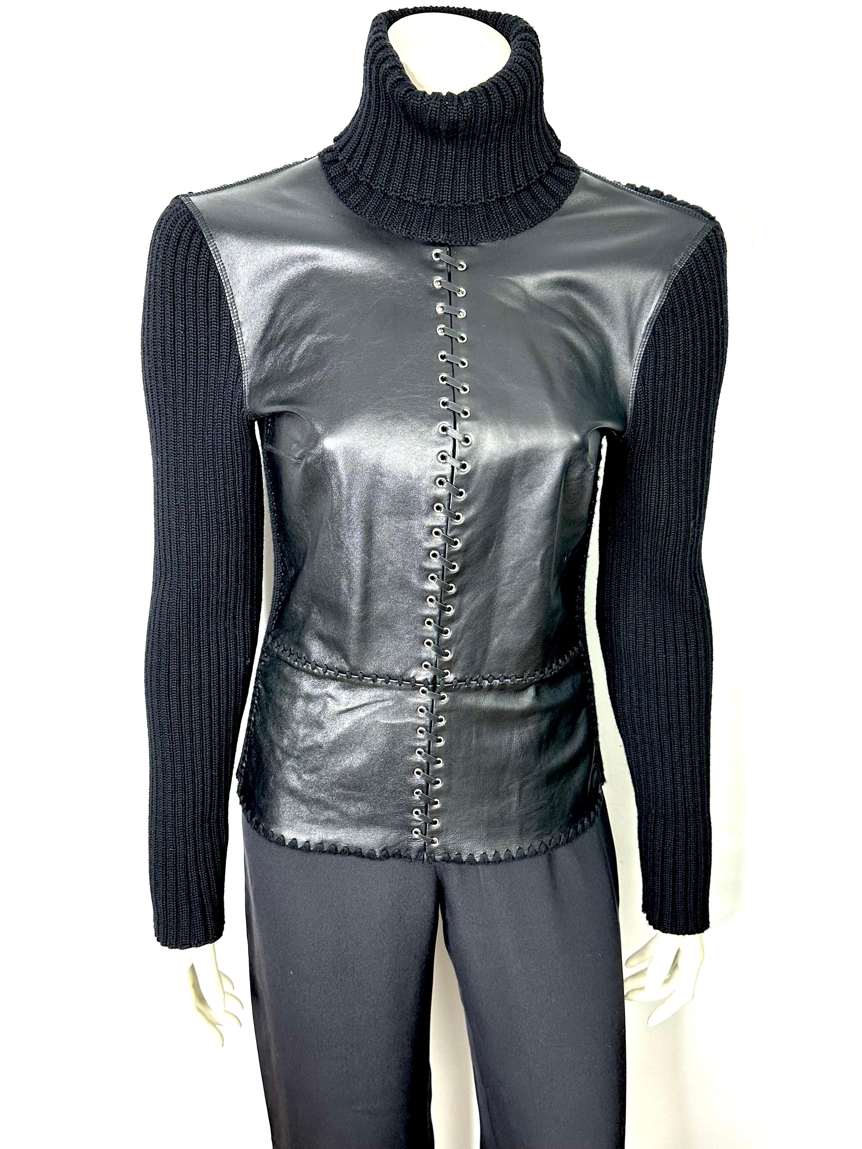 Paco Rabanne 2000s rollneck sweater in ribbed wool with riveted leather yoke at center joined by an interlaced leather lace.
Warm, wearable and unlined, this sweater will give your outfit a chic, Rock edge.
Size 42, please refer to