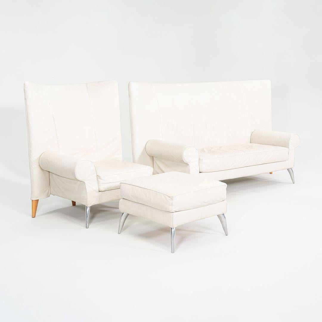 This is a Royalton chair and ottoman, originally designed by Philippe Starck in 1988. These particular pieces were produced by Driade in Italy in the 2000s. The chair features curved front legs in polished cast aluminum and legs of solid beech in