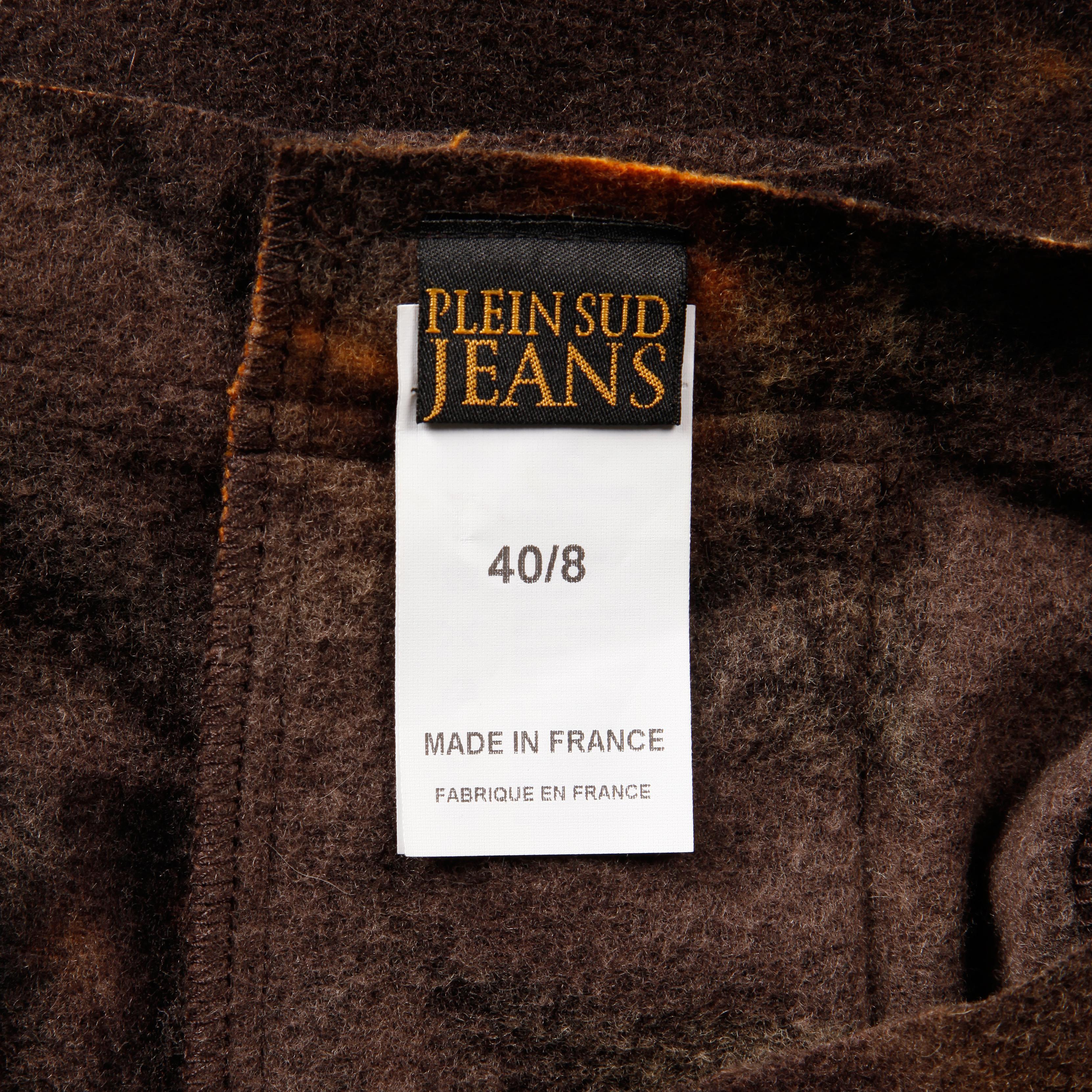 Unique mini skirt by Plein Sud Jeans done in a tie dyed felted wool with leather panel and lace up sides. Unlined with side zip closure. The marked size is 40/8. 80% wool, 20% nylon. The low waist measures 28