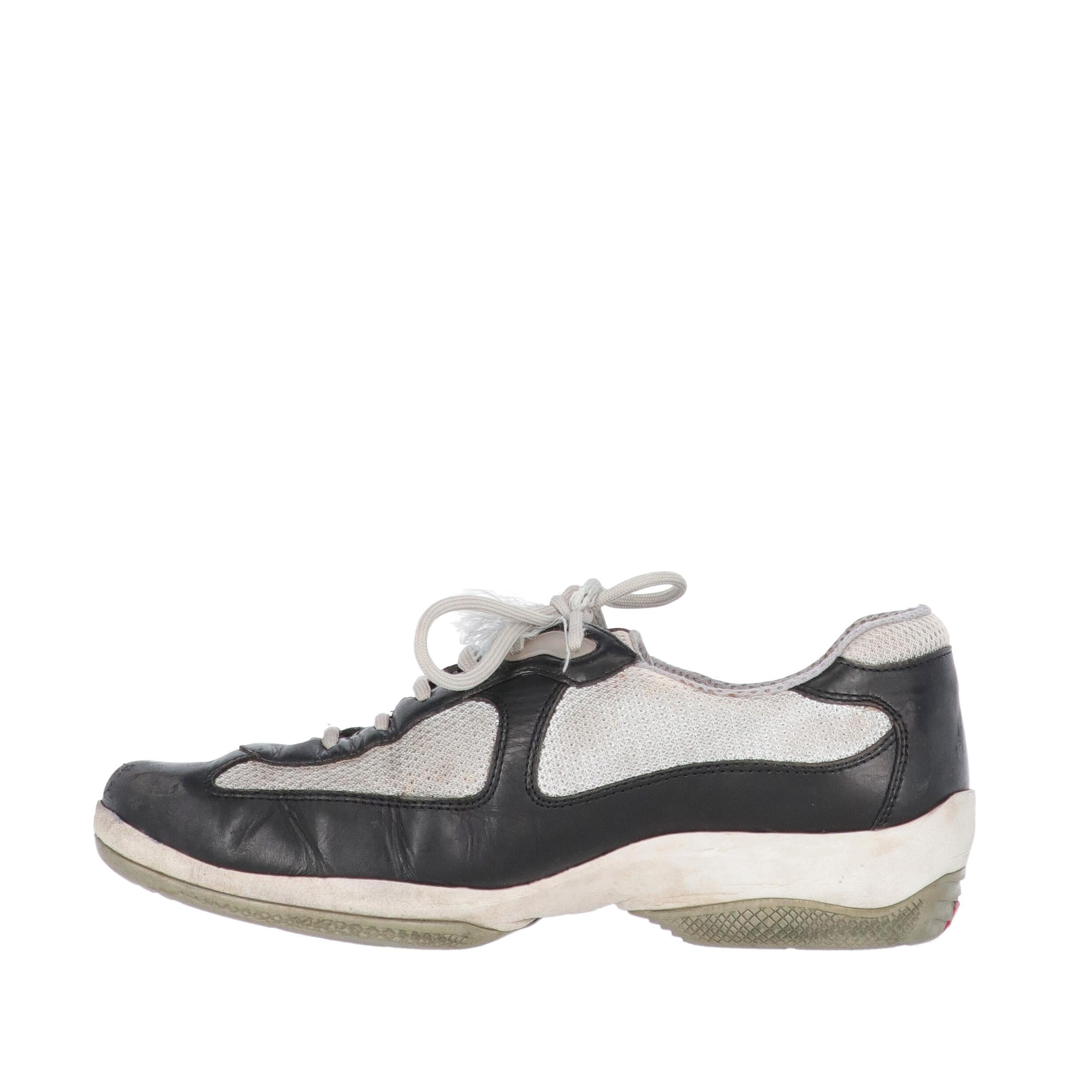 Prada grey technical fabric and dark blue leather lace-up shoes, round toe and rubber sole with Prada Linea Rossa logo. 
The shoes show light signs of wear on the leather, the sole and the inside, and a frayed string, as shown in the pictures.
