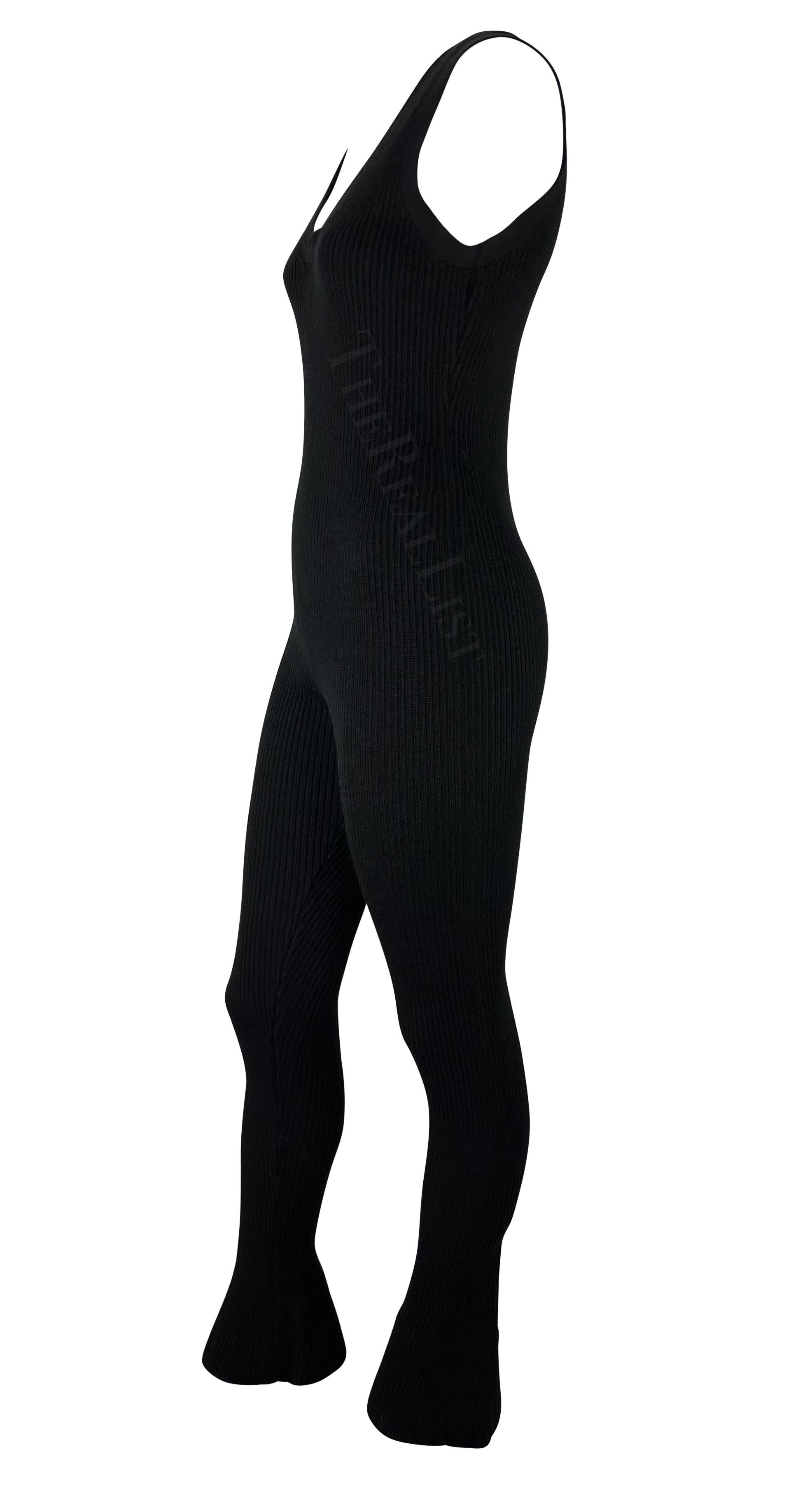 Presenting a fabulous black knit Prada body suit, designed by Miuccia Prada. From the early 2000s, this fabulous catsuit is entirely rib-knit and features a wide scoop neckline, wide tank-style shoulder straps, and a flare-cut cuffs. Stirrup straps