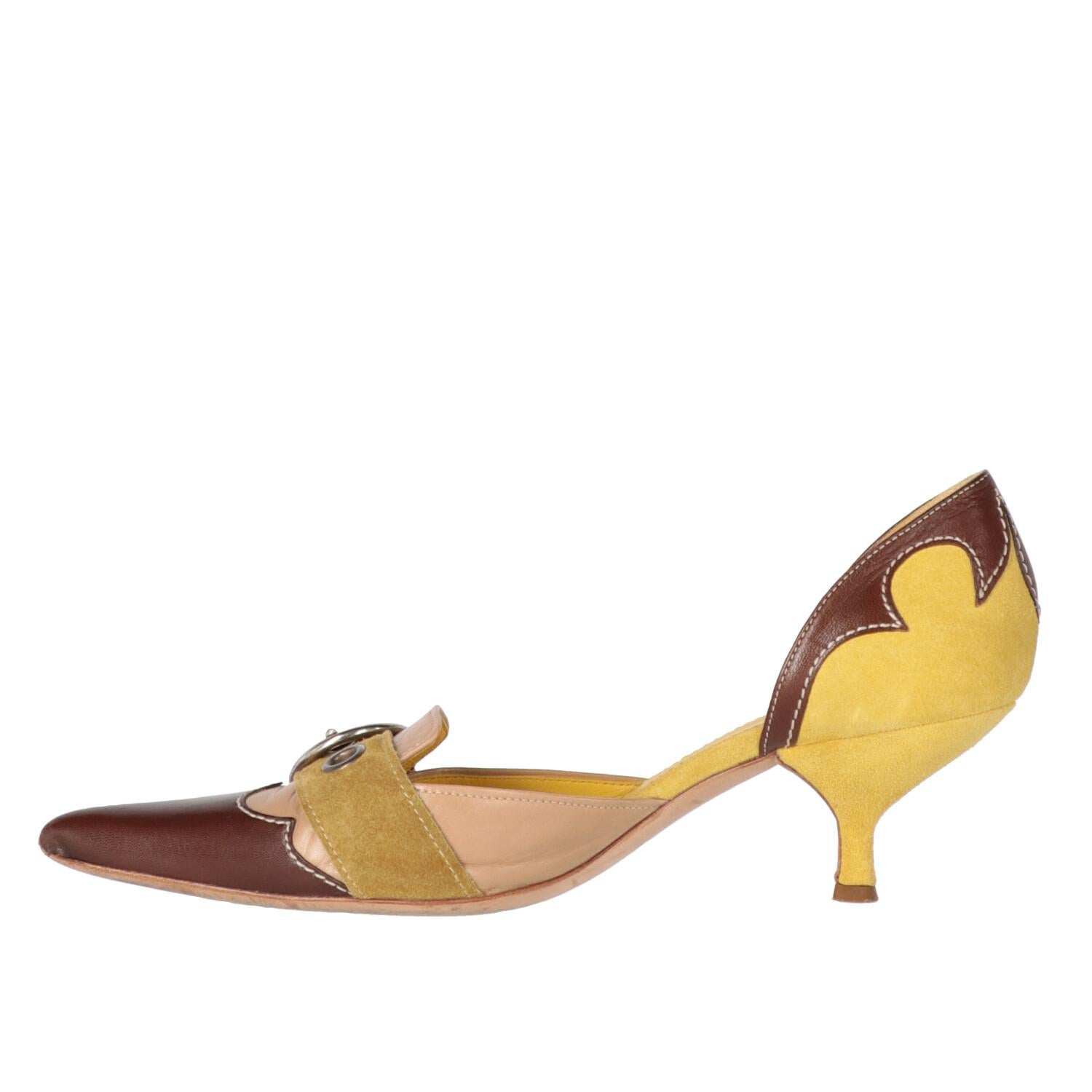 A.N.G.E.L.O. Vintage - ITALY

Prada leather and suede kitten heels pumps in shades of yellow, brown and beige. Pointed model and open at the sides, front buckle in silver metal and low heel.

The item shows a stain and signs of wear, as shows in the