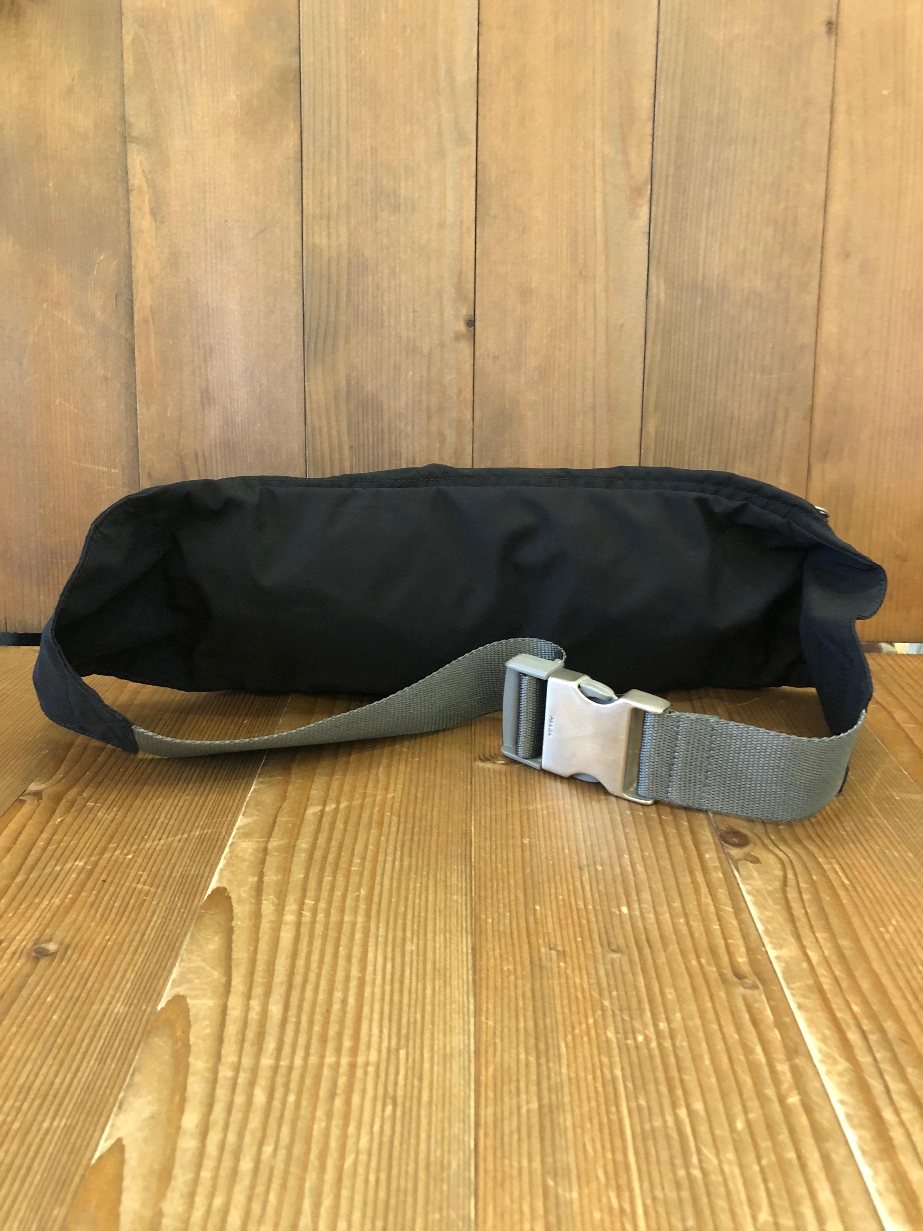 Vintage PRADA Spots polyester bumbag in black featuring two zippered compartments. Made in Italy. Buckle closure. Measures 12 x 5 x 2 inches Up to 36 inch waist

Condition - Some signs of wear consistent with age and normal use

Outside: Minor marks