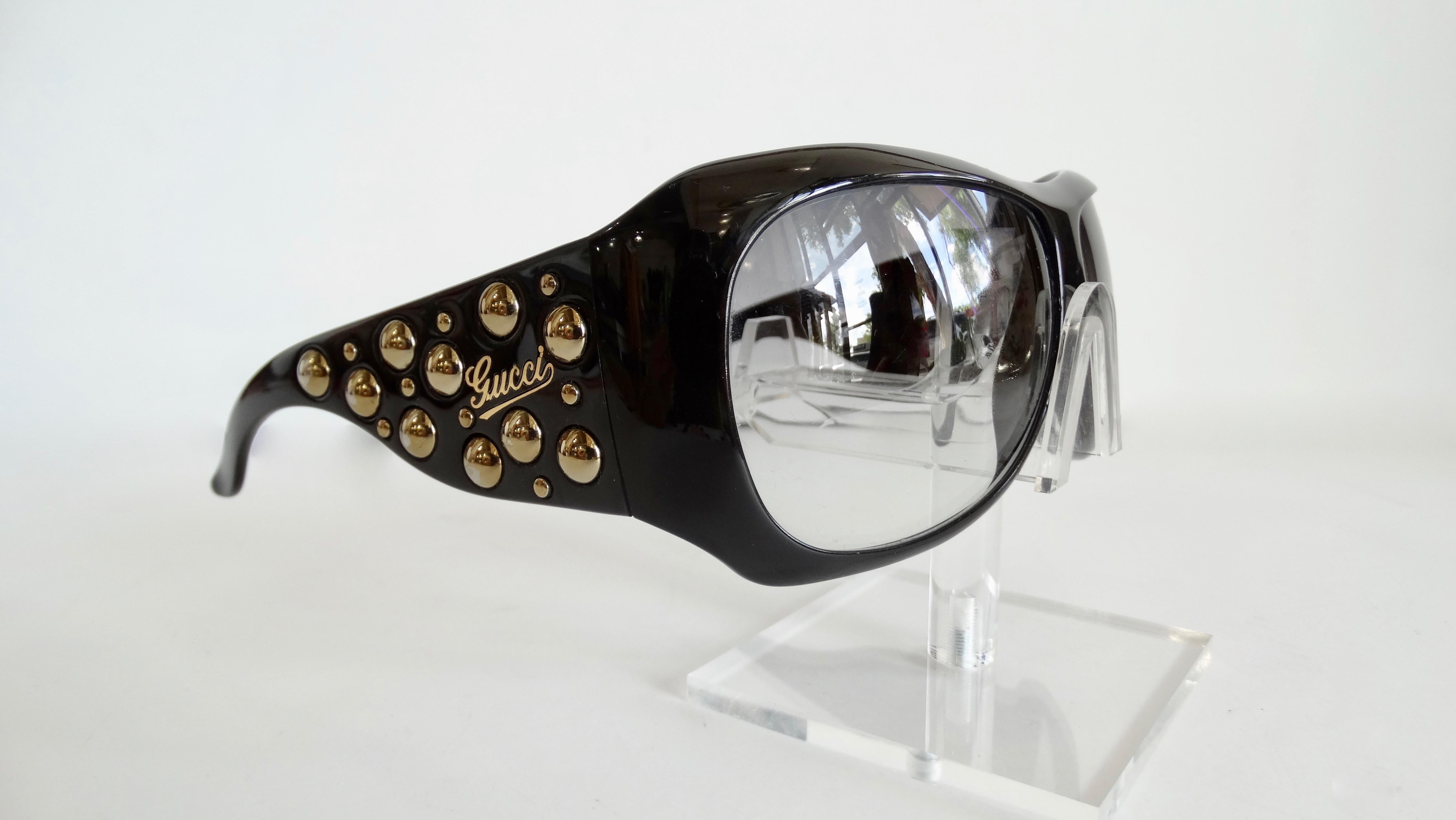 Elevate your everyday eyewear with this Gucci sunglasses! Circa 2000s, these more rare style of Gucci shield sunglasses feature black gradient lenses. The arms are embellished with gold plated studs and are signed 