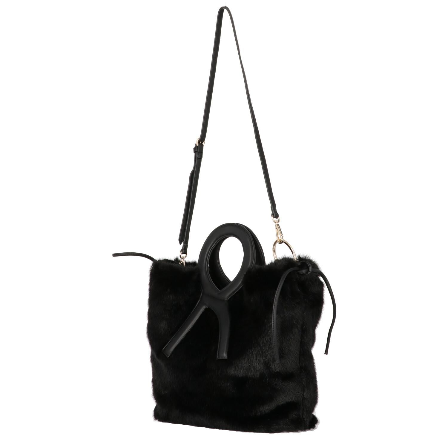 A.N.G.E.L.O. Vintage - ITALY
Roberta Di Camerino black fake fur tote bag. Model with double leather handles, adjustable shoulder strap, golden metal details and magnetic button closure.
Years: 2000s

Made in Italy

Flat measurements

Height: 33